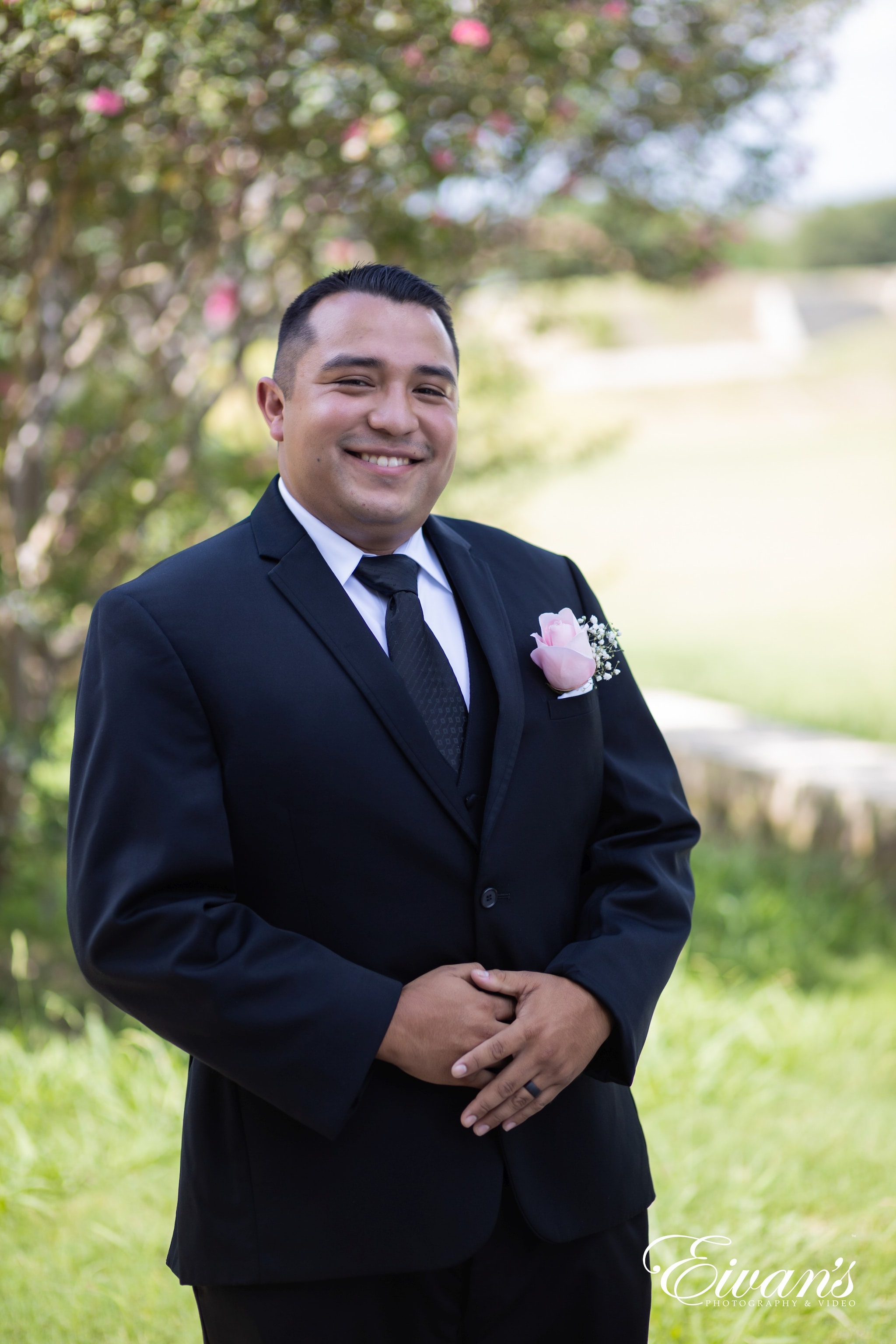 man in black suit jacket smiling