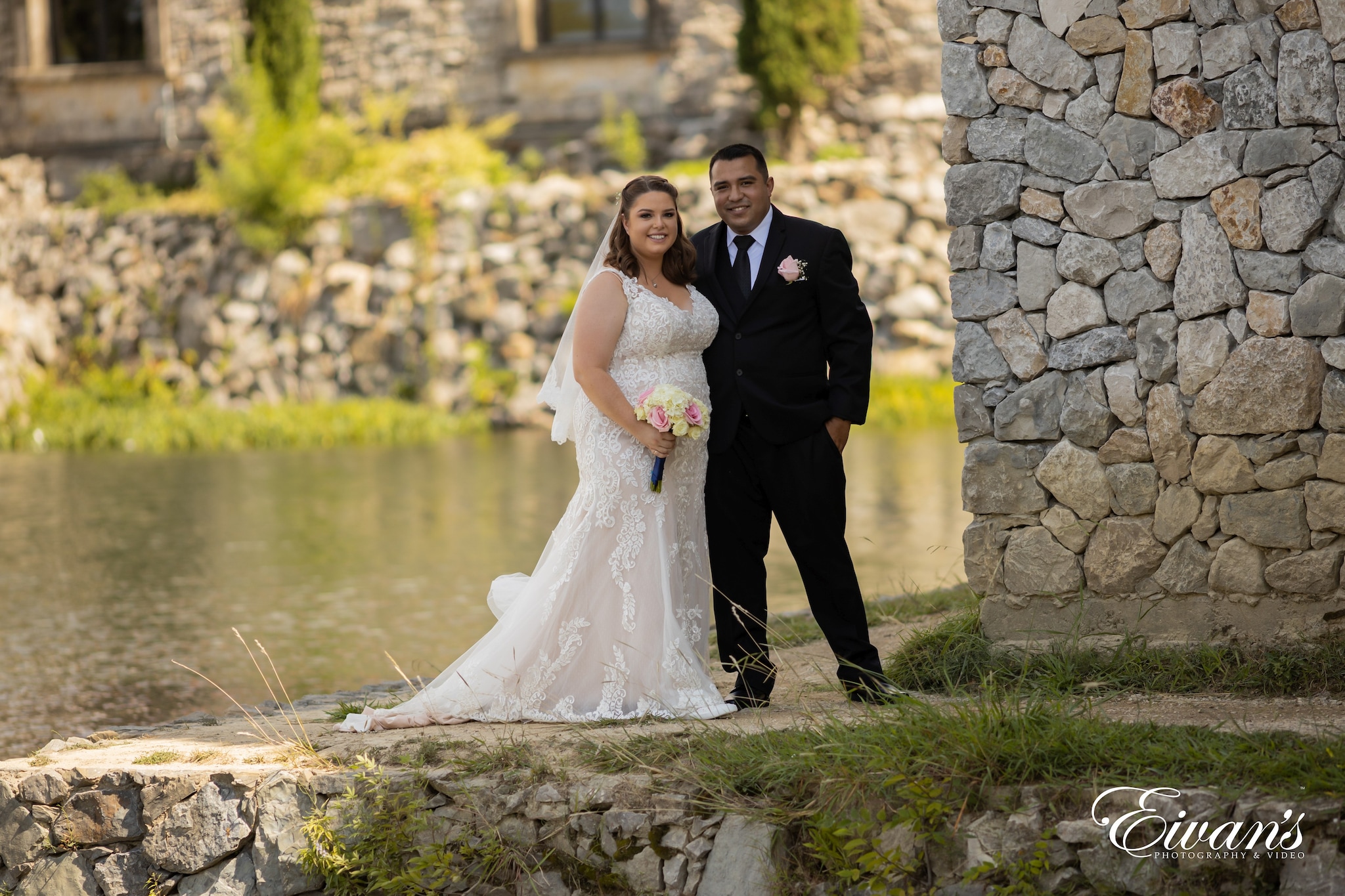 bride and groom standing on green grass field during daytime