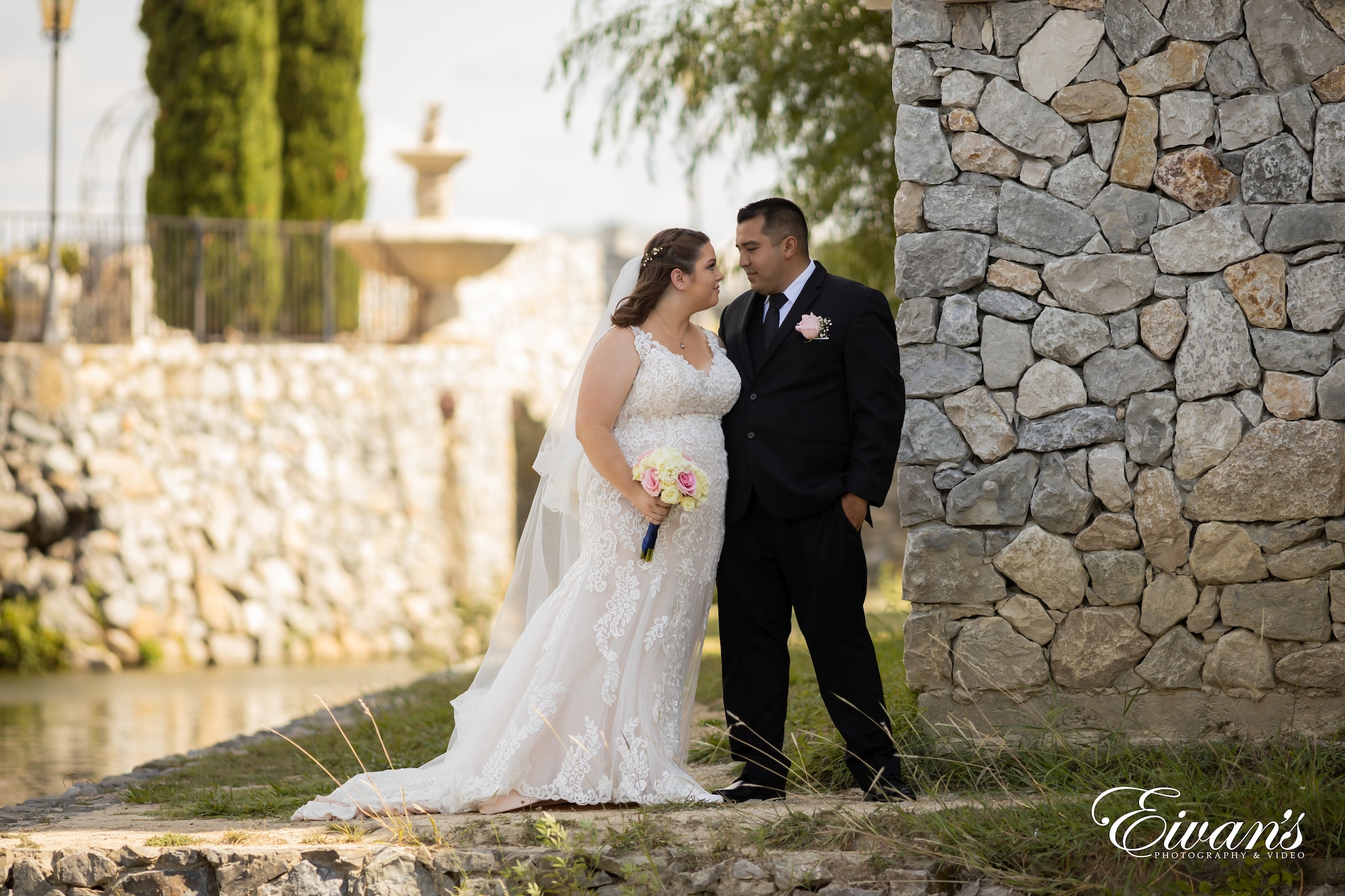 man in black suit and woman in white wedding dress