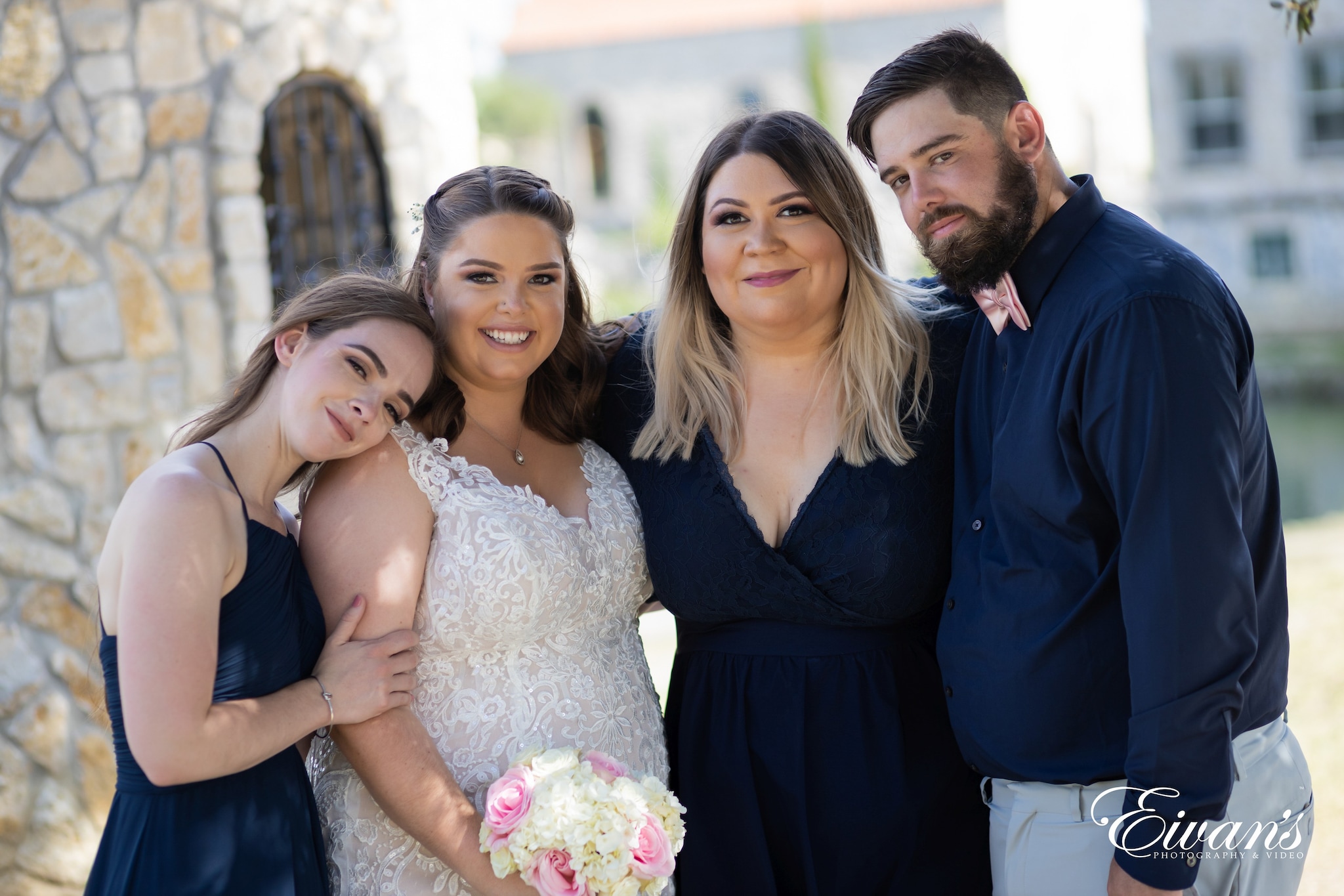 woman in white floral lace wedding dress beside man in blue suit jacket