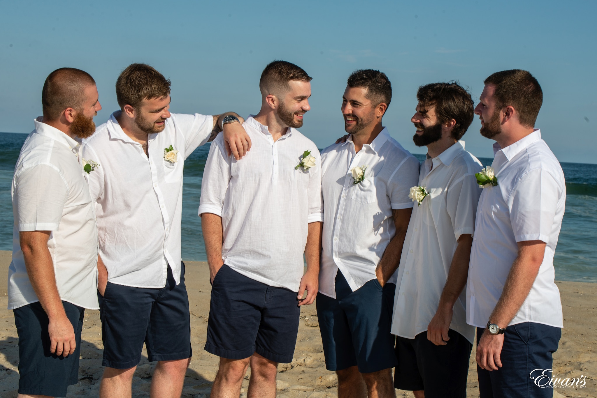 men in white polo shirt and blue shorts standing beside each other