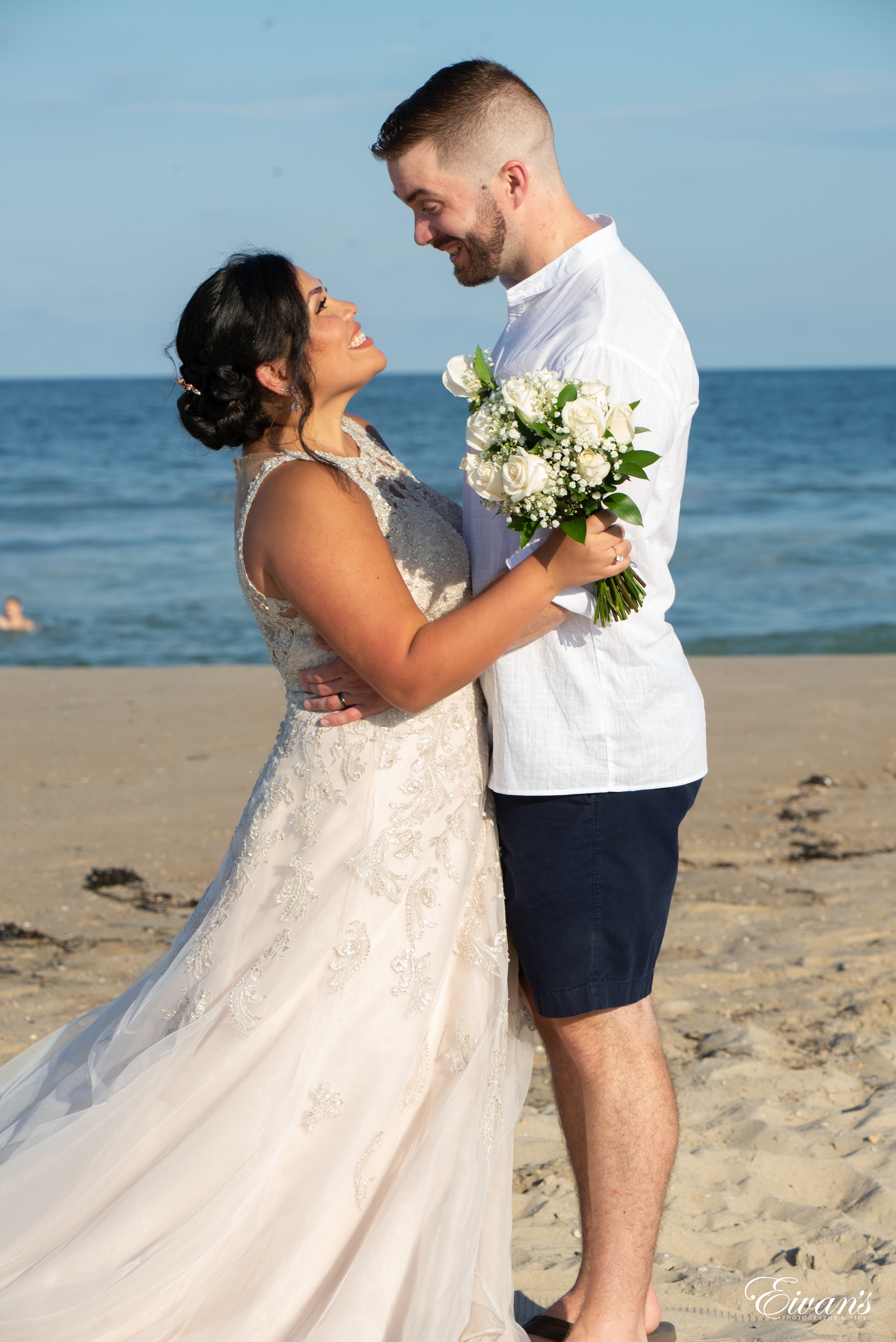 man and woman kissing on beach during daytime
