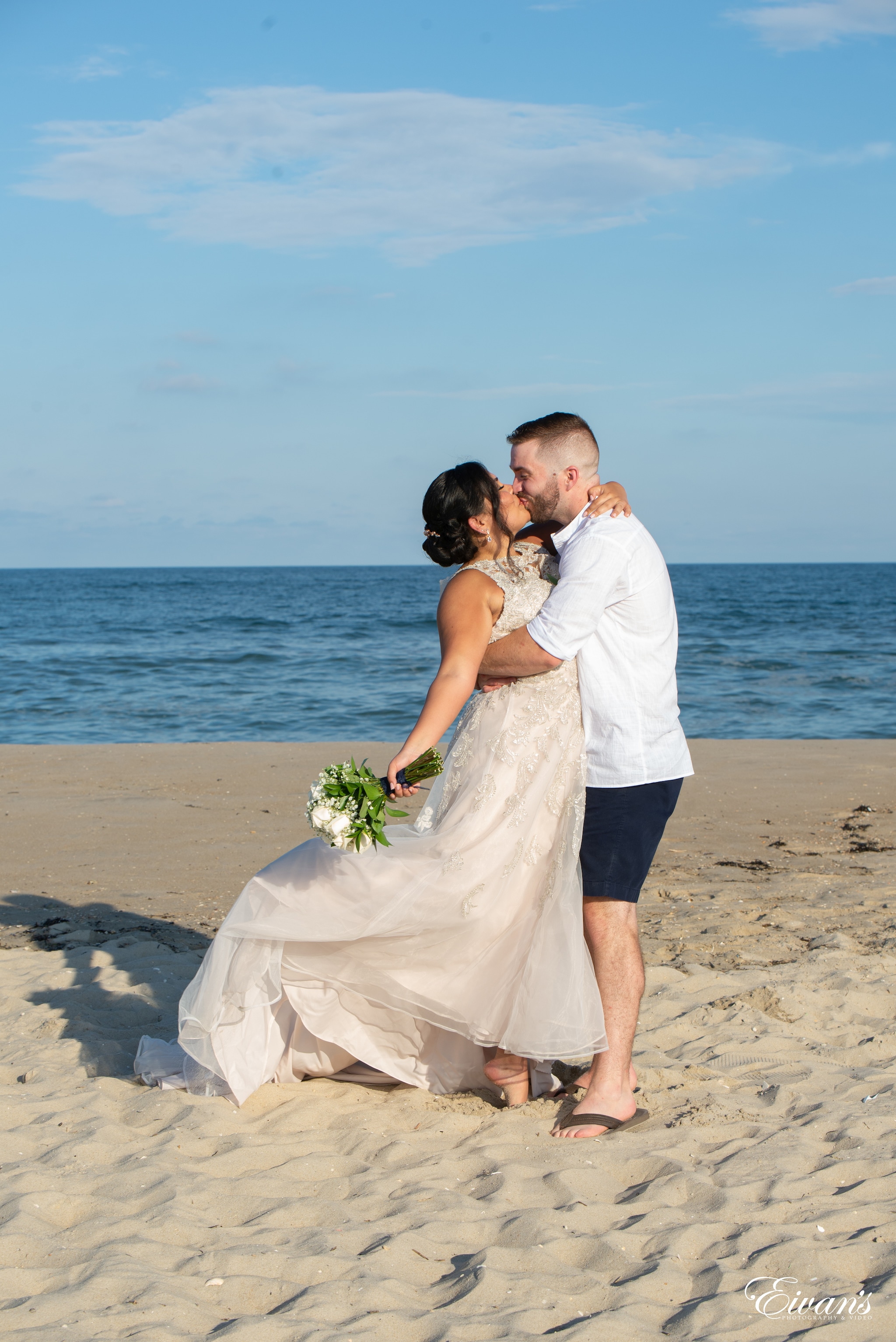 man and woman kissing on beach during daytime