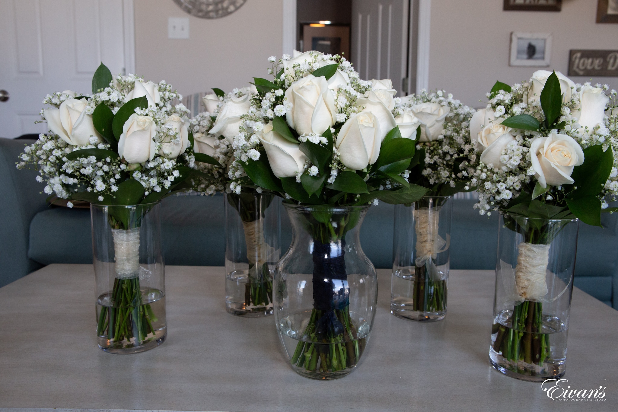 white roses in clear glass vase