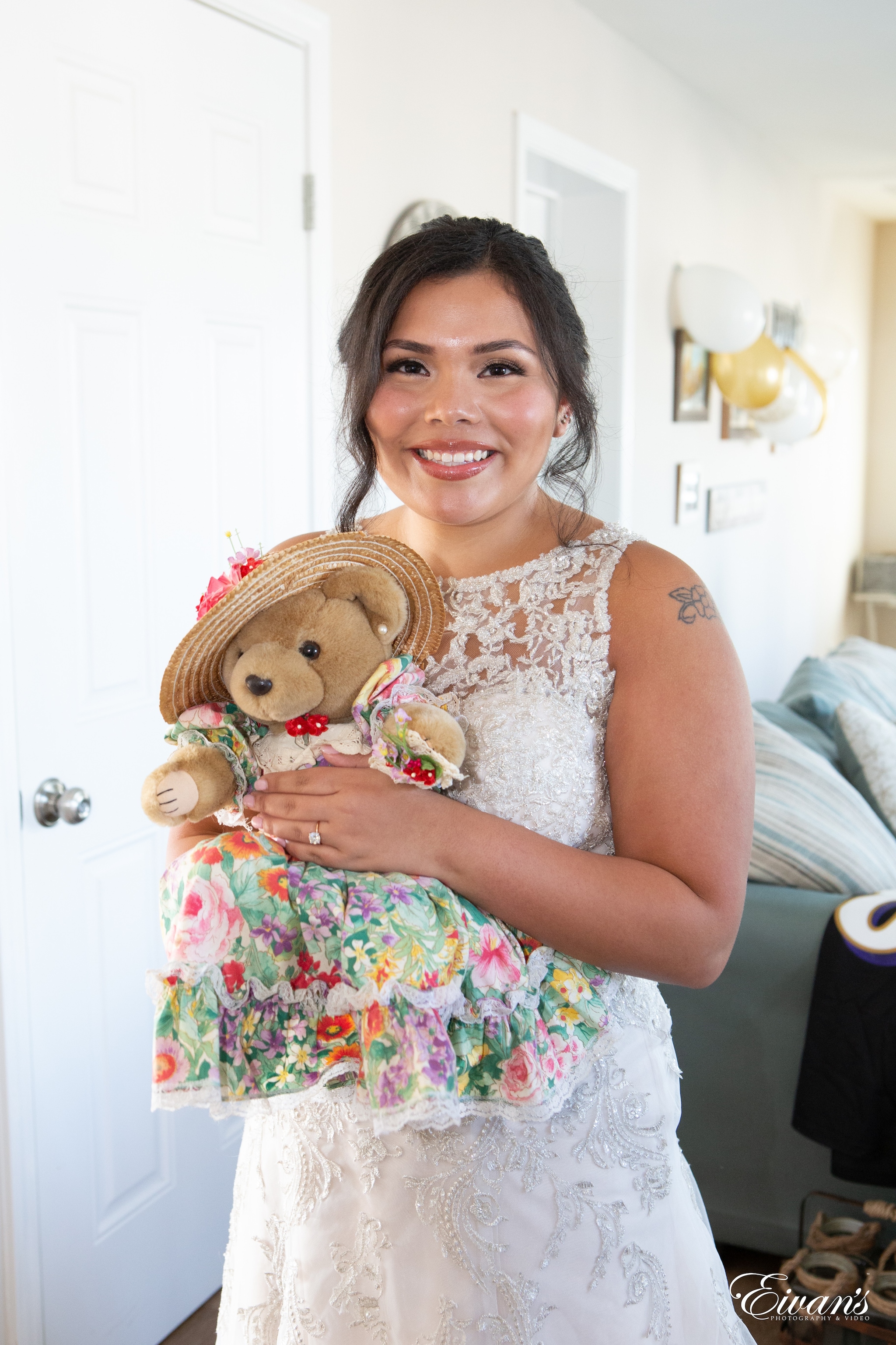 woman in white floral dress holding brown toy