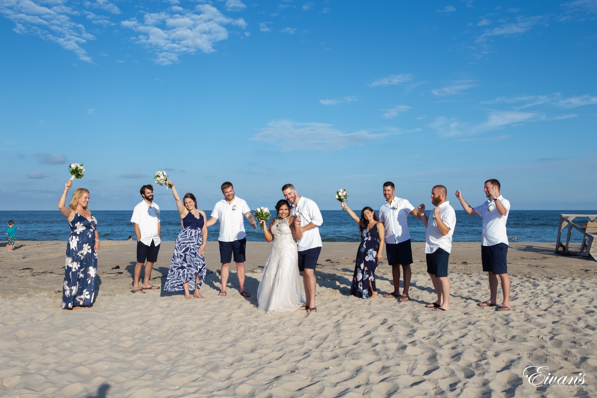 group of people standing on white sand during daytime