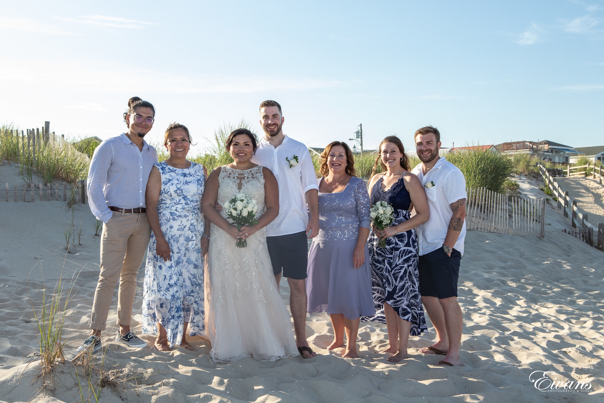 group of people standing on gray sand during daytime