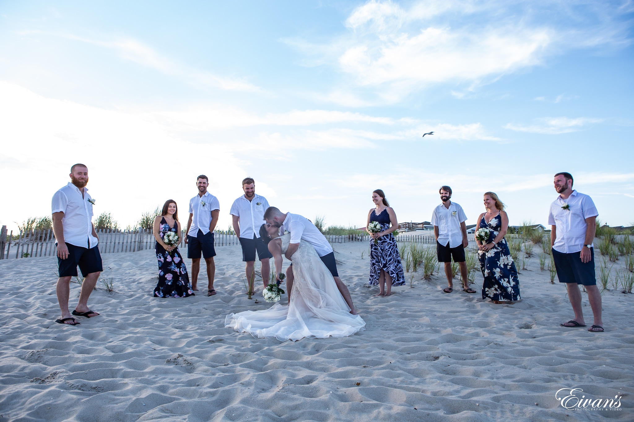 group of people standing on gray sand during daytime