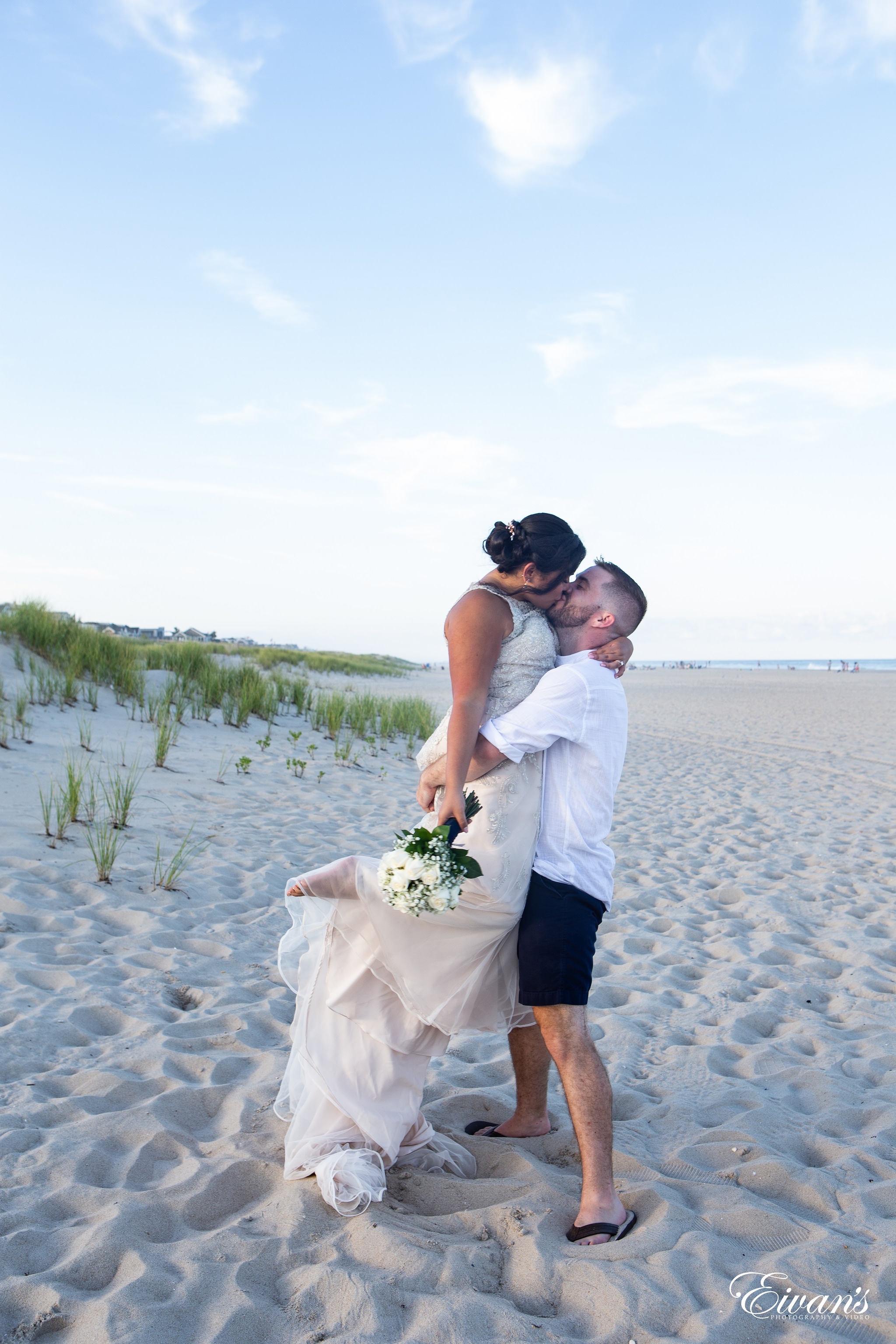man and woman kissing on beach during daytime