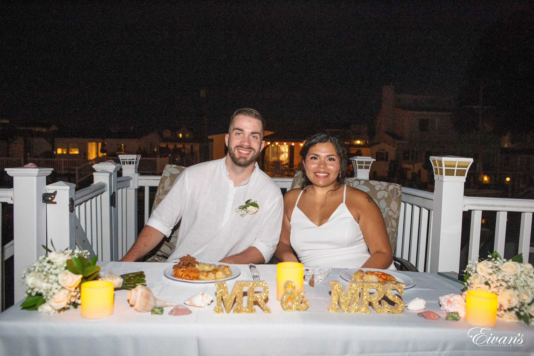 man and woman sitting on chair in front of table with food
