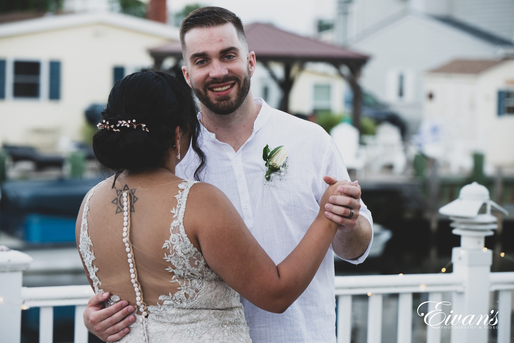 man in white dress shirt holding white flower bouquet