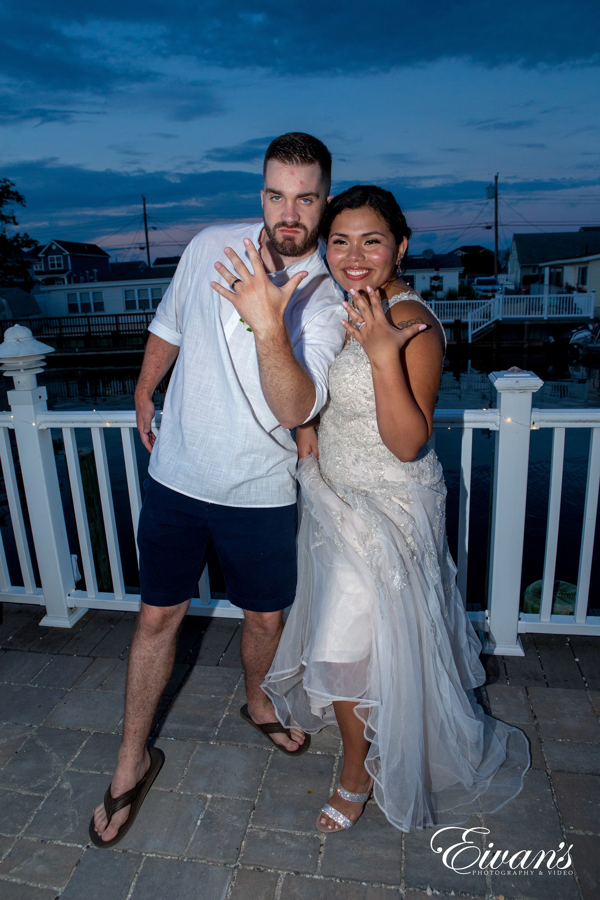 man in blue shorts hugging woman in white dress