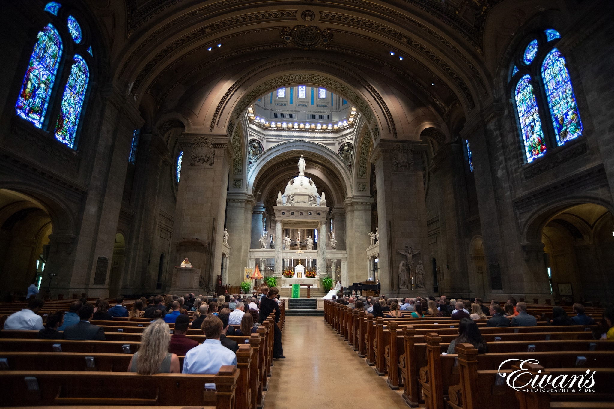 people sitting on brown wooden chairs inside church
