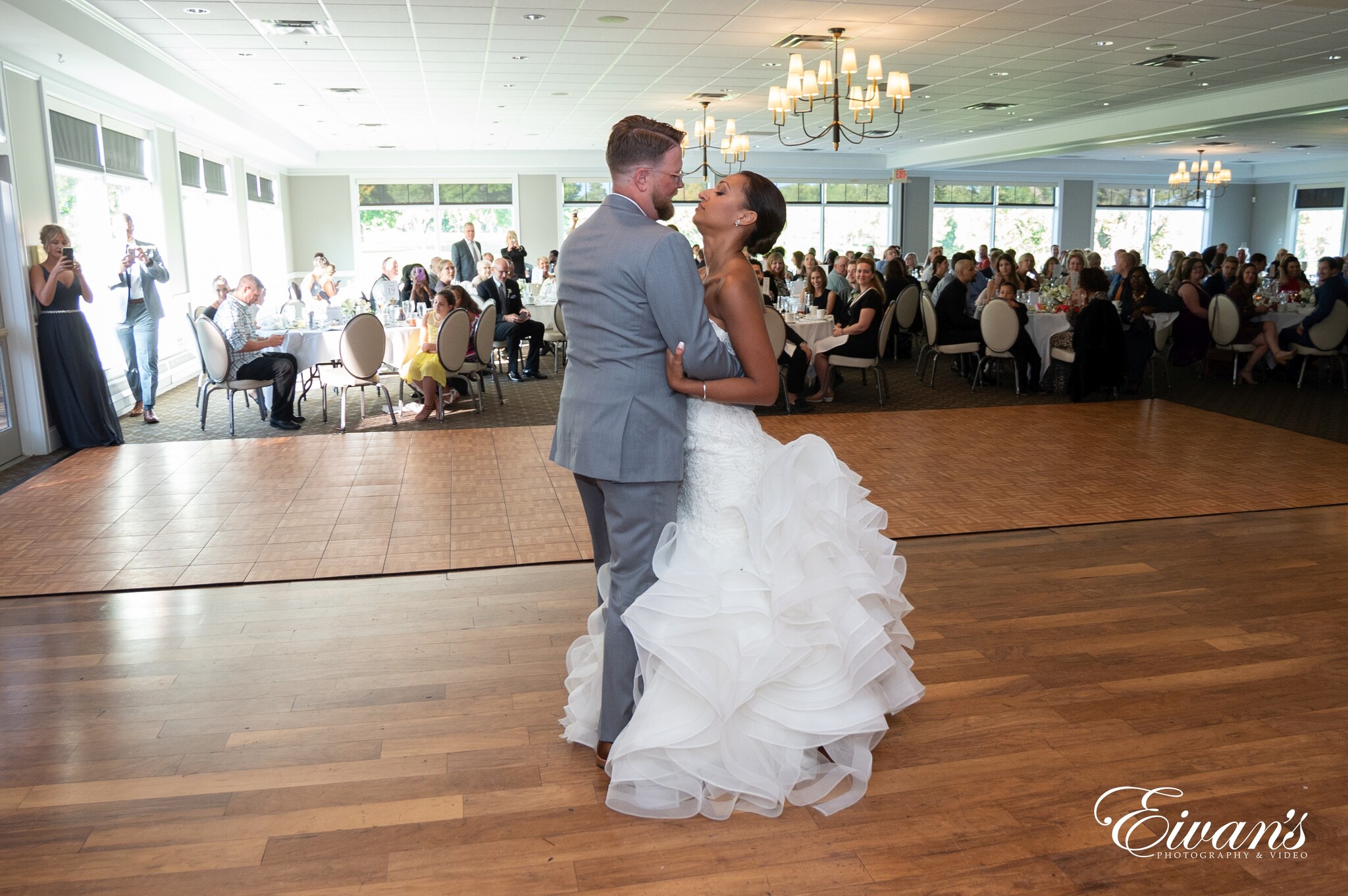 man in black suit jacket and woman in white wedding dress