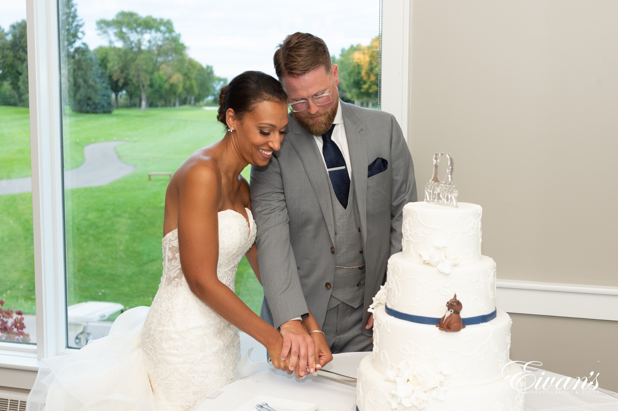 man in gray suit standing beside woman in white wedding dress