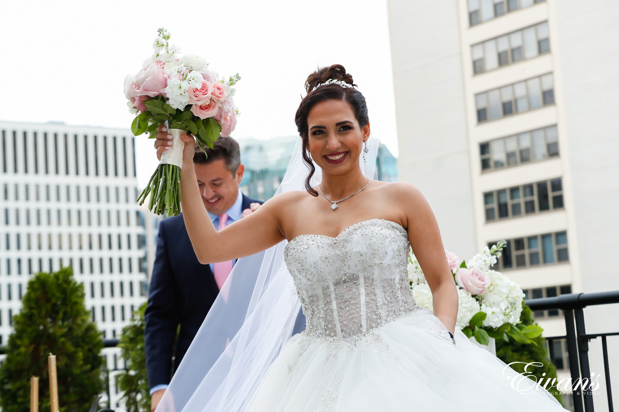woman in white wedding dress holding bouquet of flowers