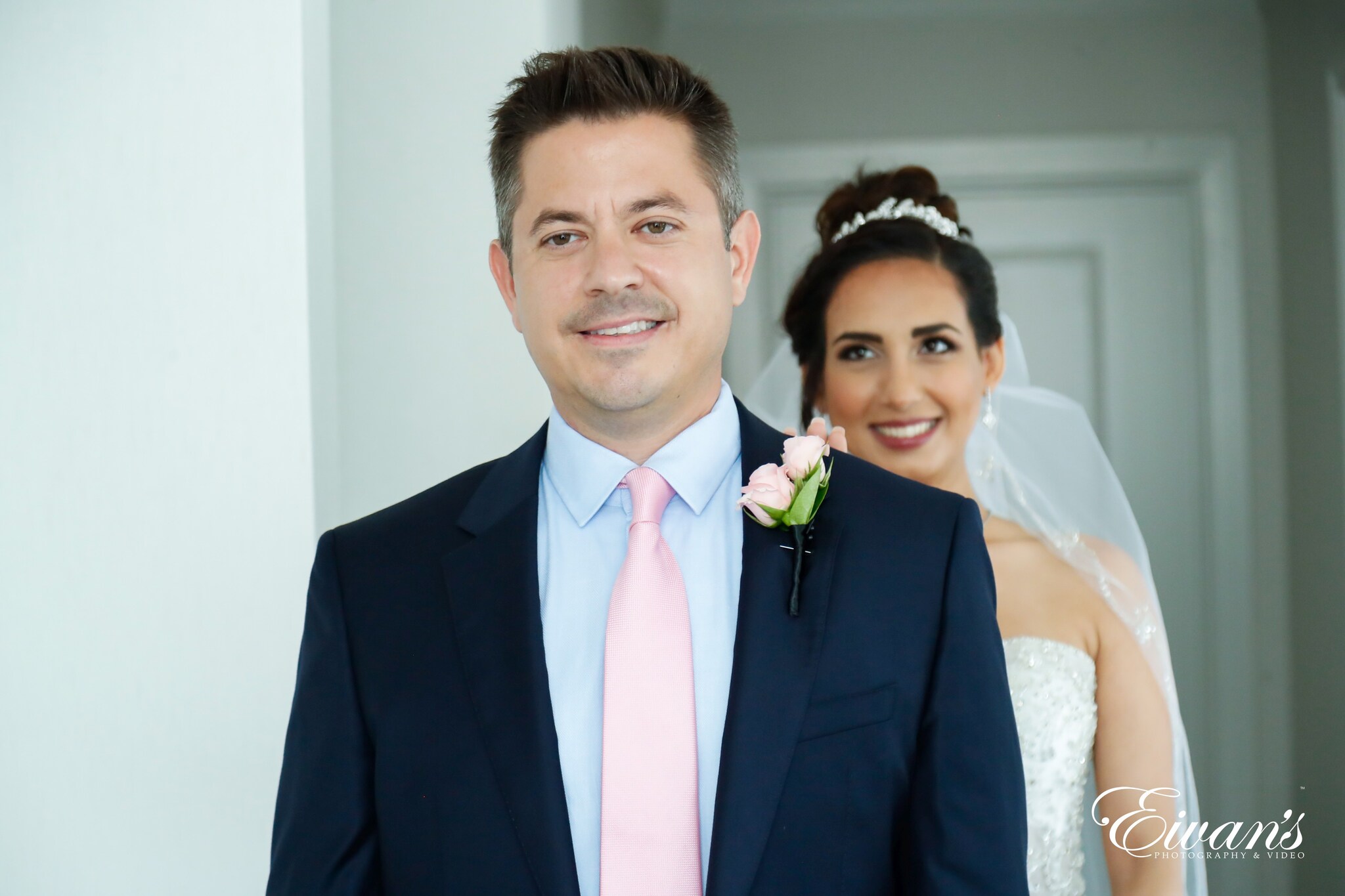 man in black suit jacket beside woman in white wedding dress