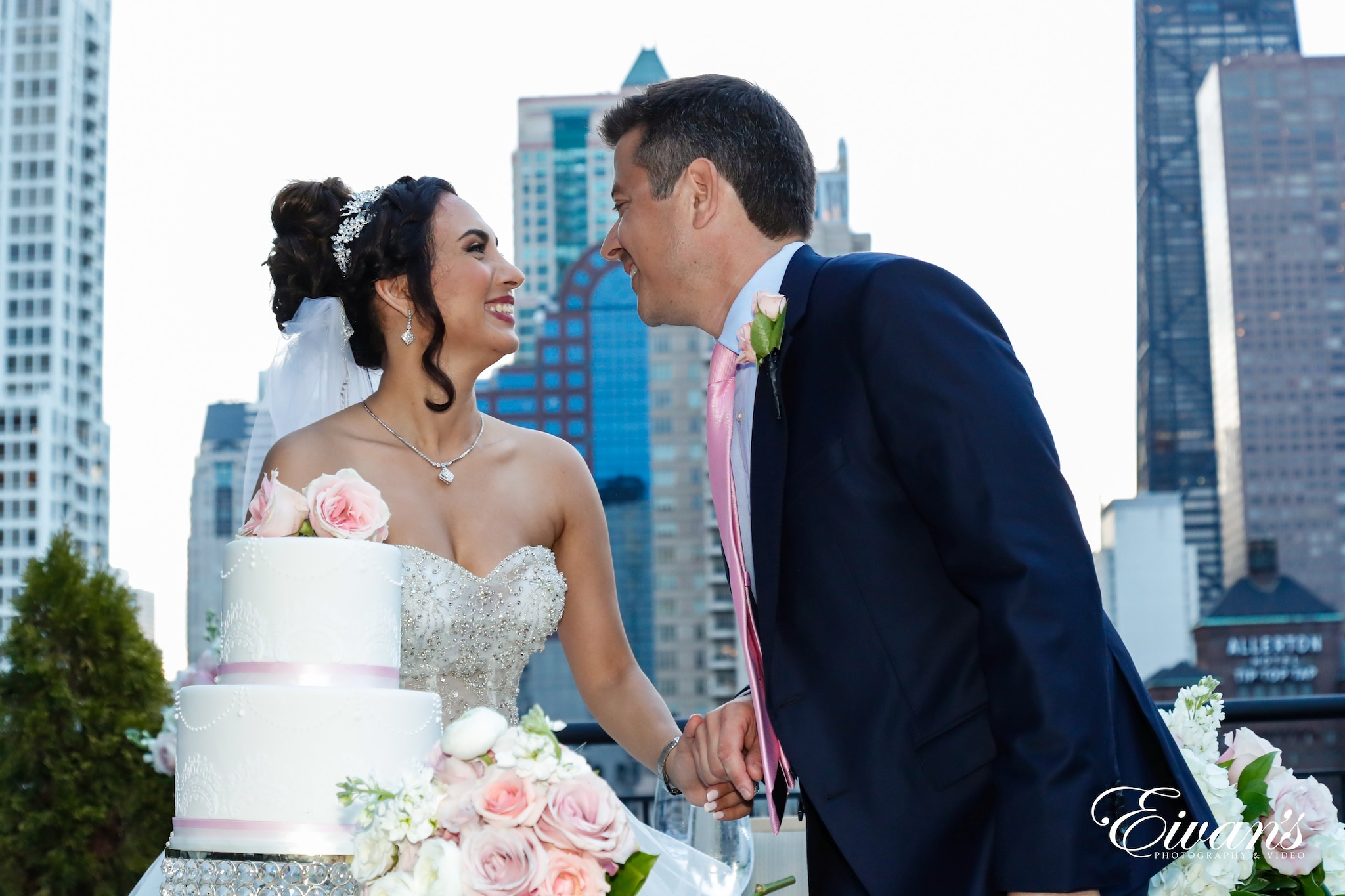 man in black suit jacket kissing woman in white wedding dress