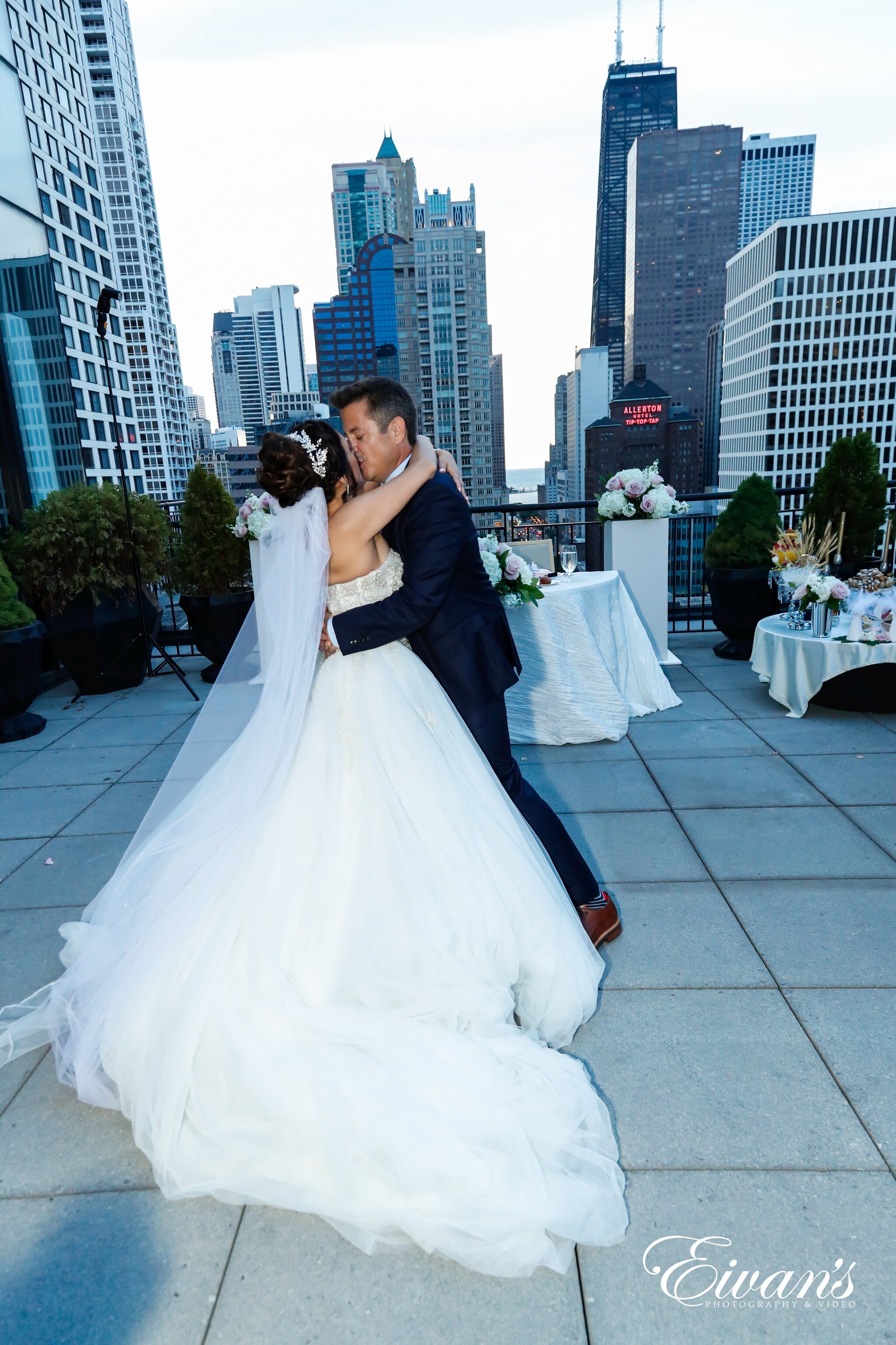woman in white wedding gown kissing man in black suit