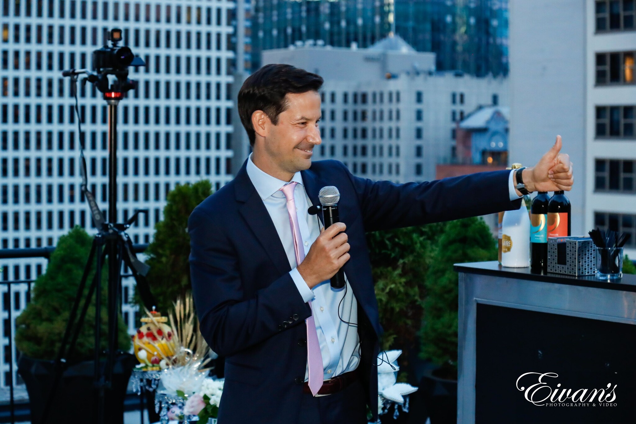 man in black suit holding microphone