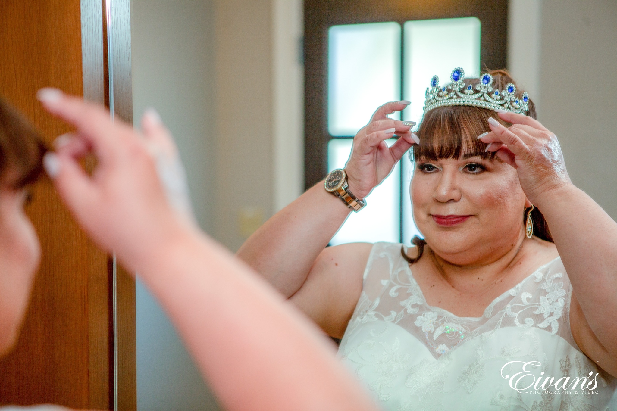 woman in white floral sleeveless dress wearing silver and gold crown