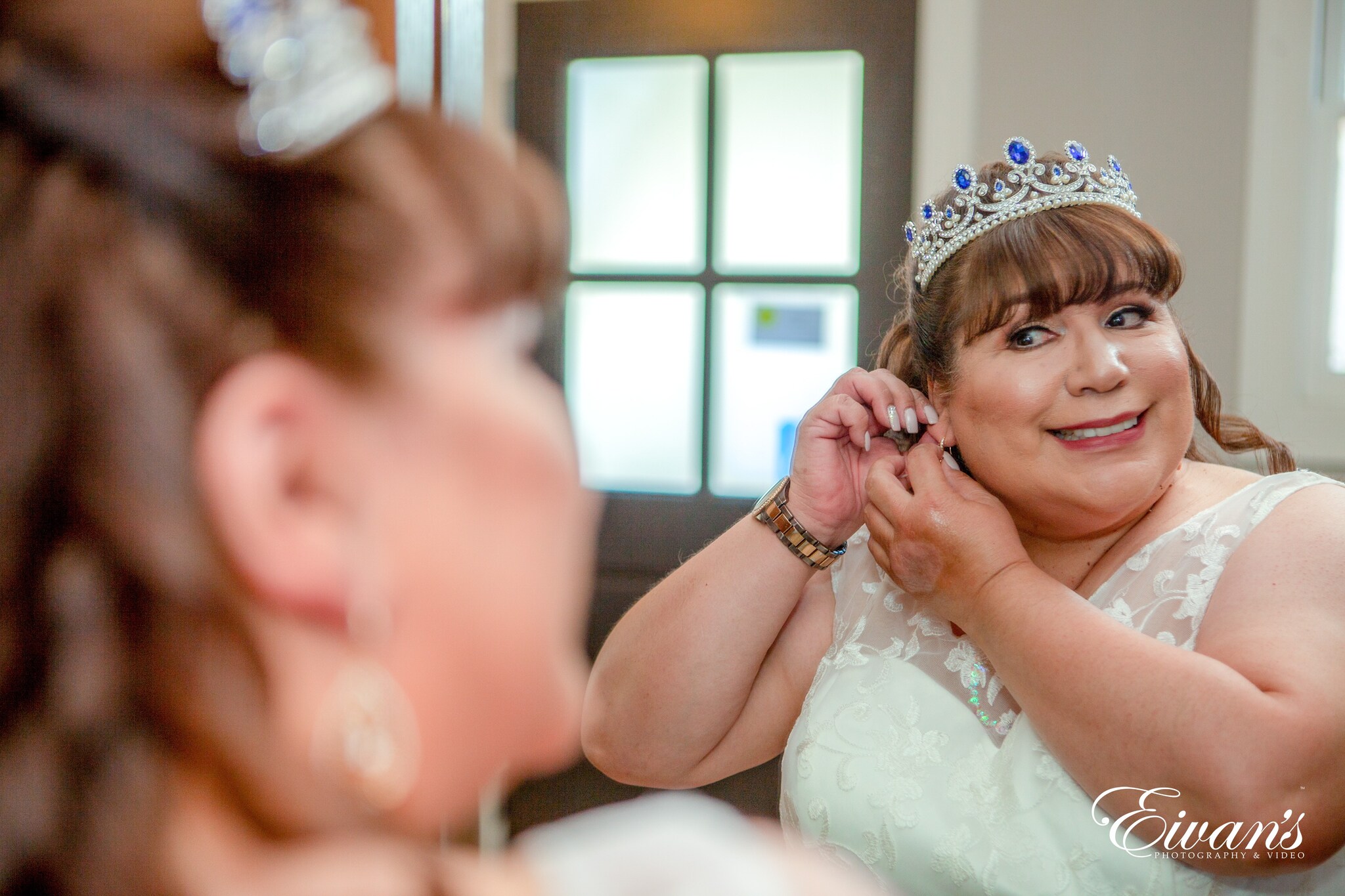 woman in white floral sleeveless dress wearing silver and gold crown