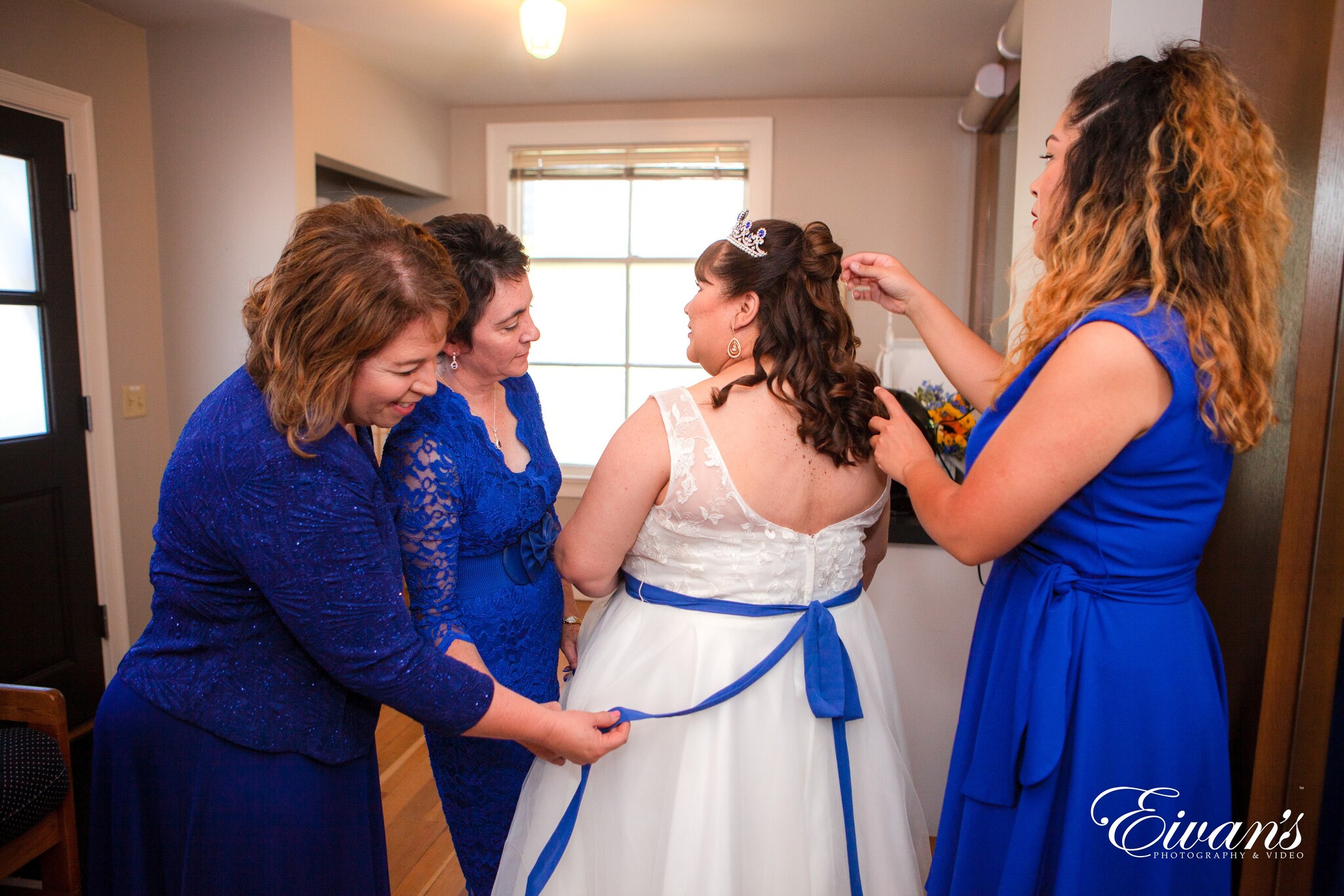woman in white dress standing beside man in blue suit
