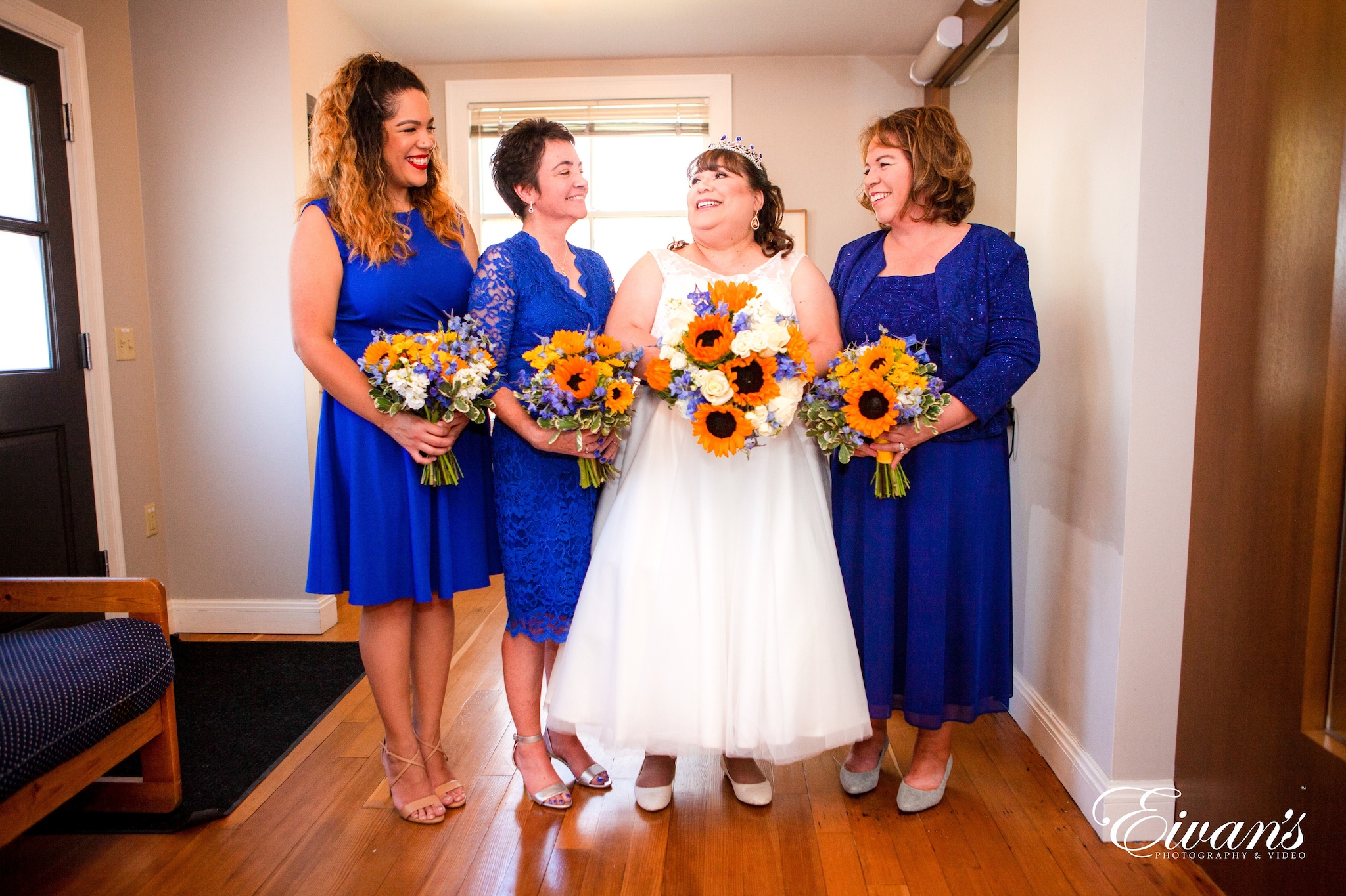 3 women holding bouquet of flowers