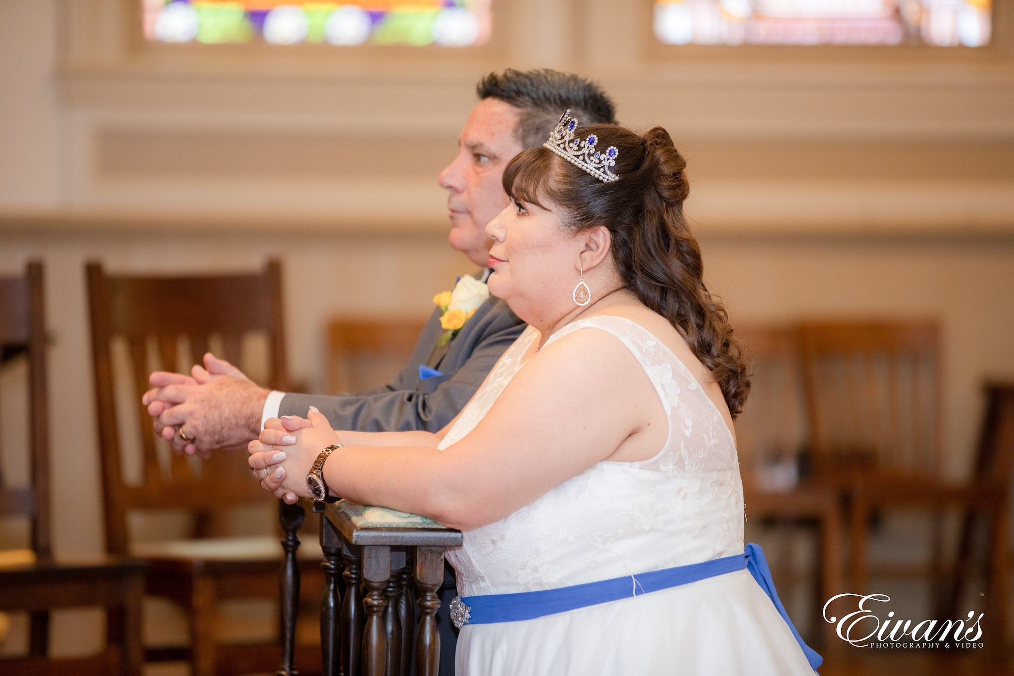 woman in white and blue dress holding hands with man in blue suit