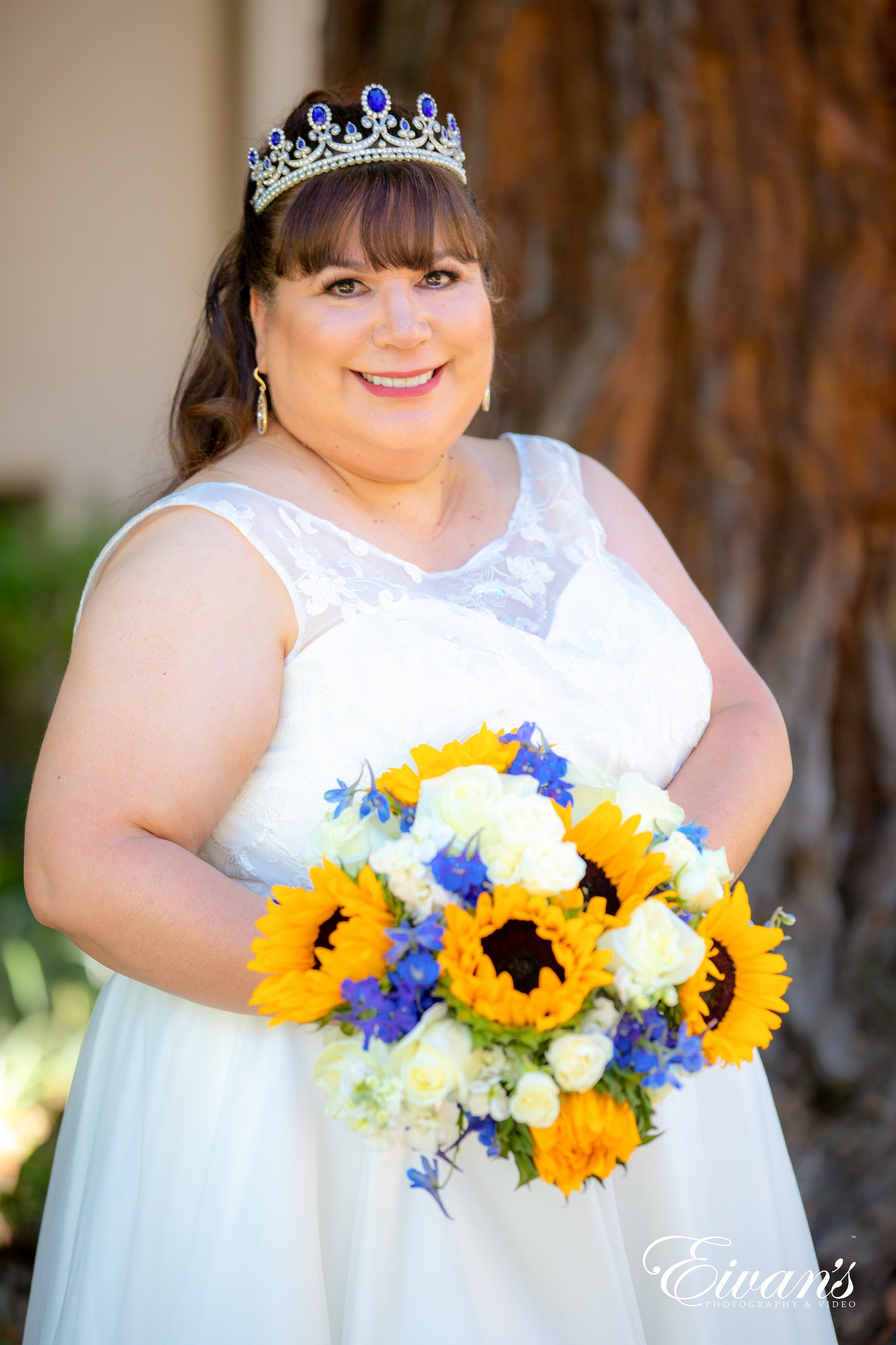girl in white sleeveless dress holding yellow and white flowers