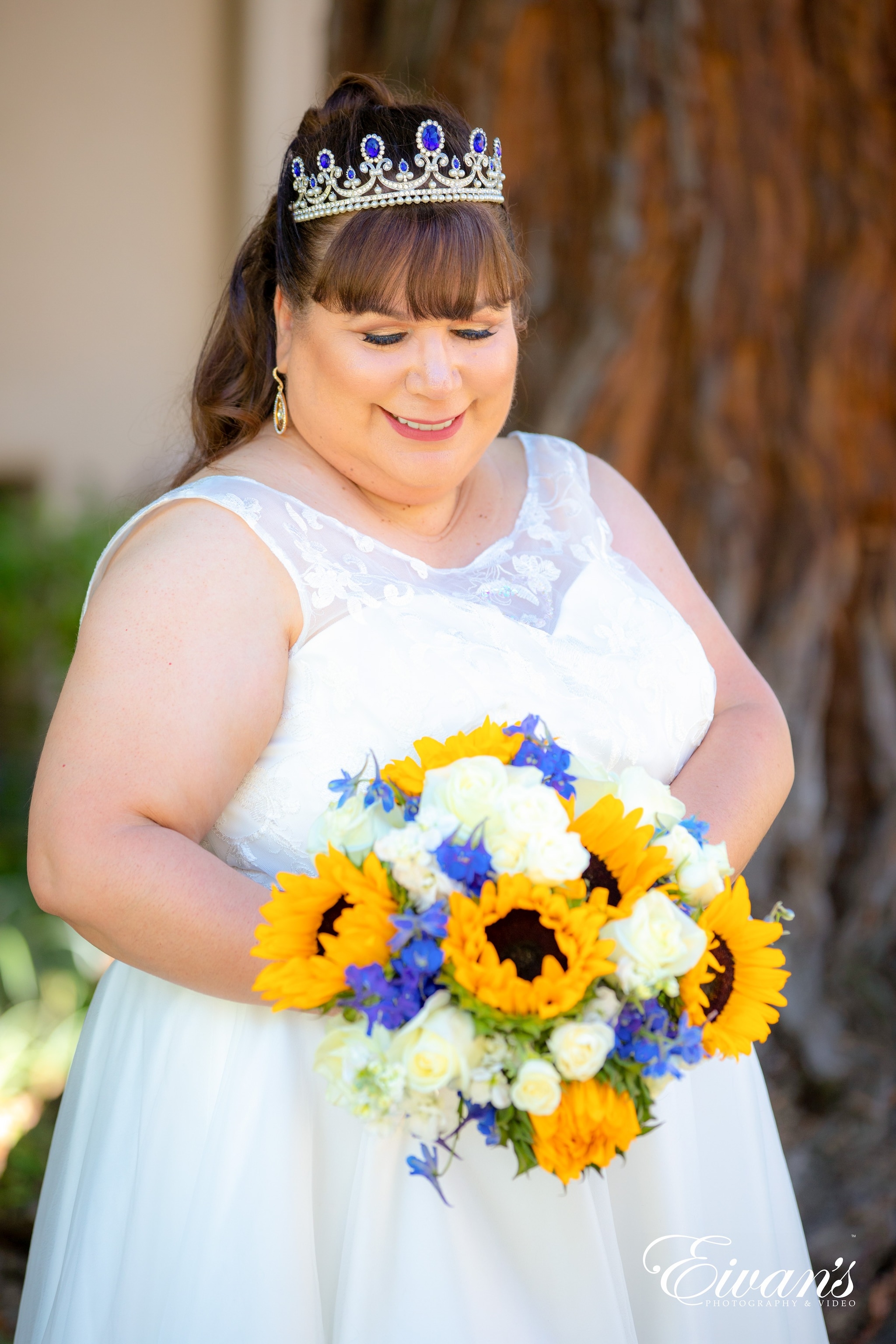 girl in white sleeveless dress holding yellow and white flowers