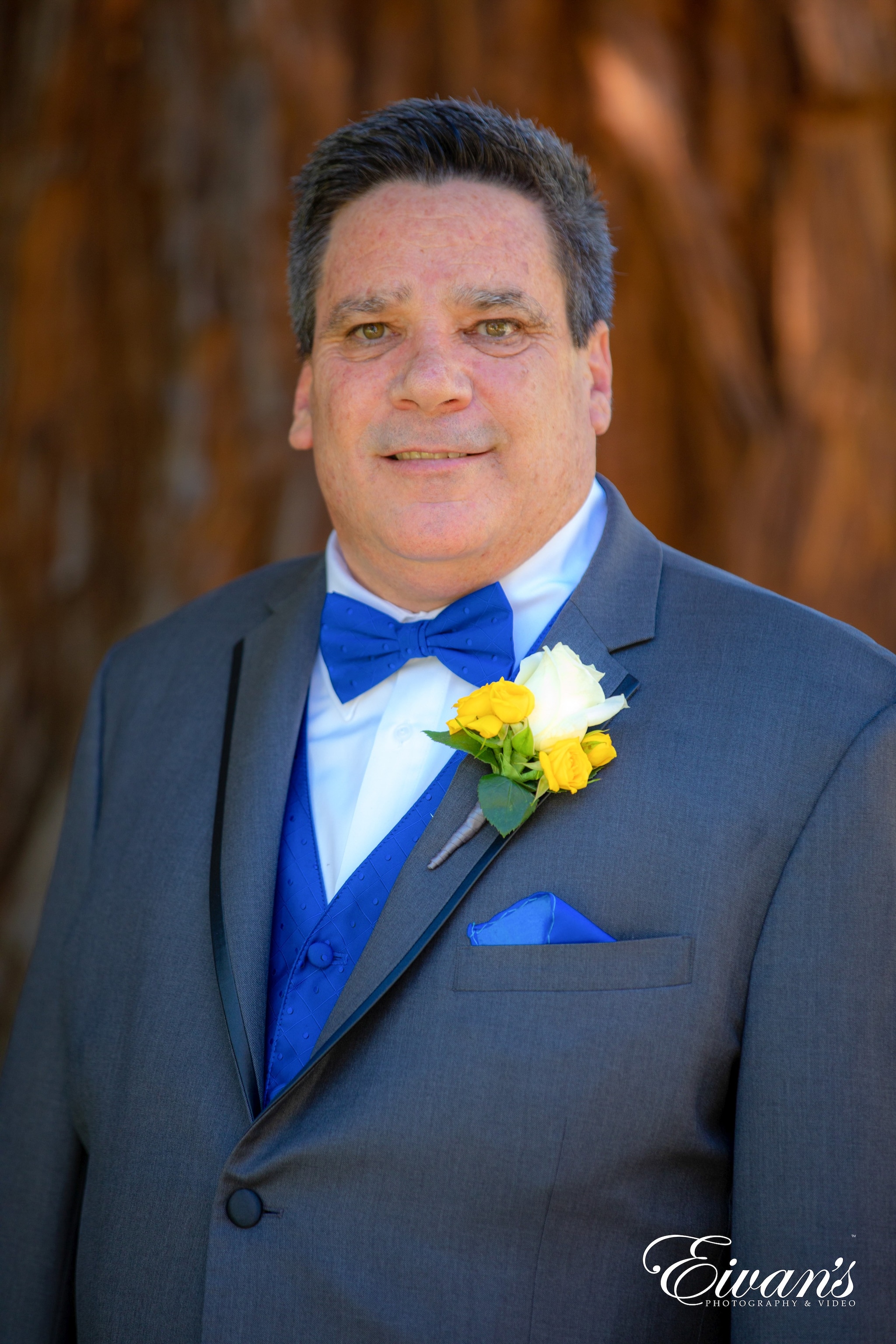 man in black suit jacket holding woman in yellow dress
