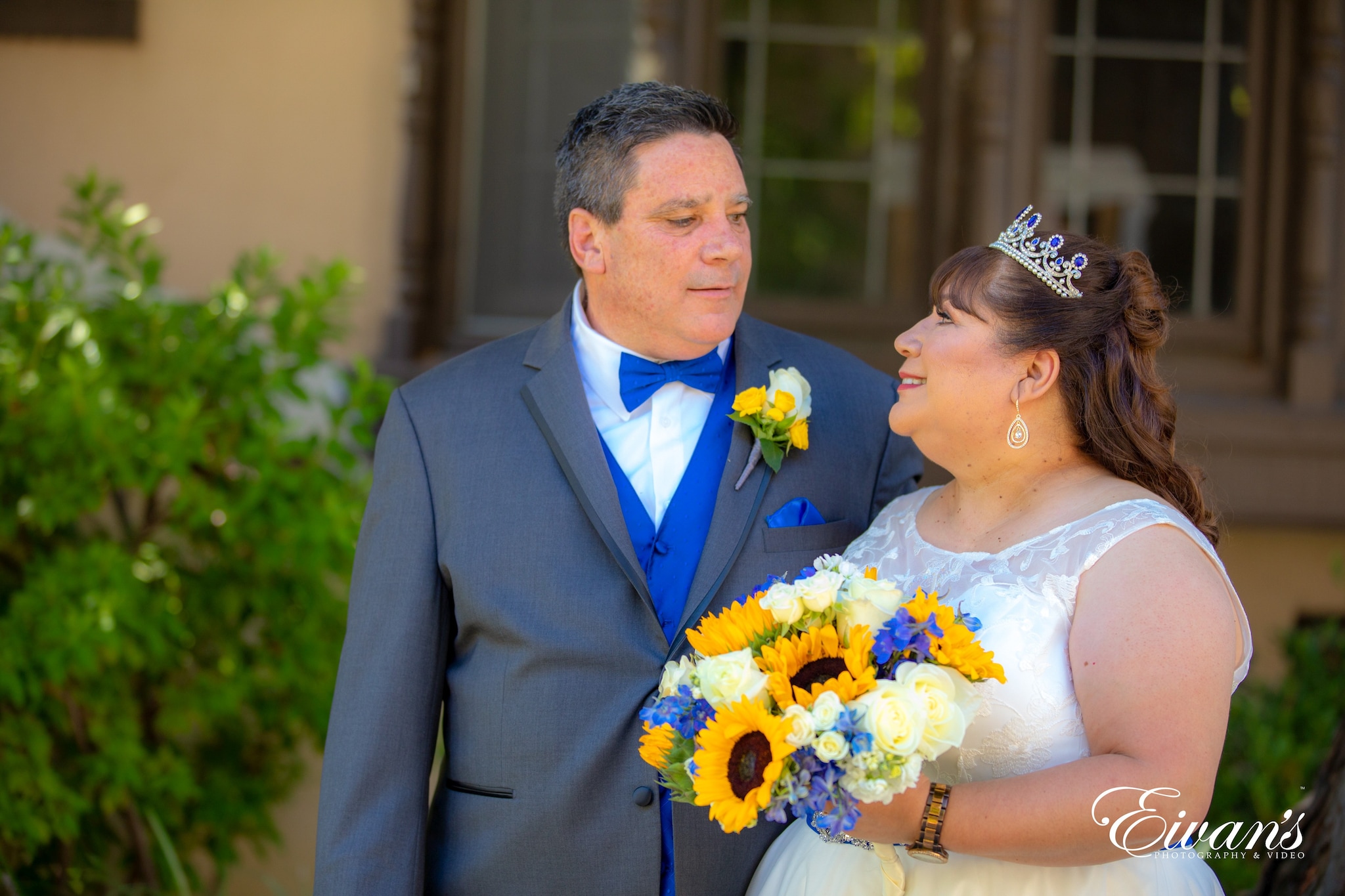 man in black suit jacket kissing woman in white wedding dress