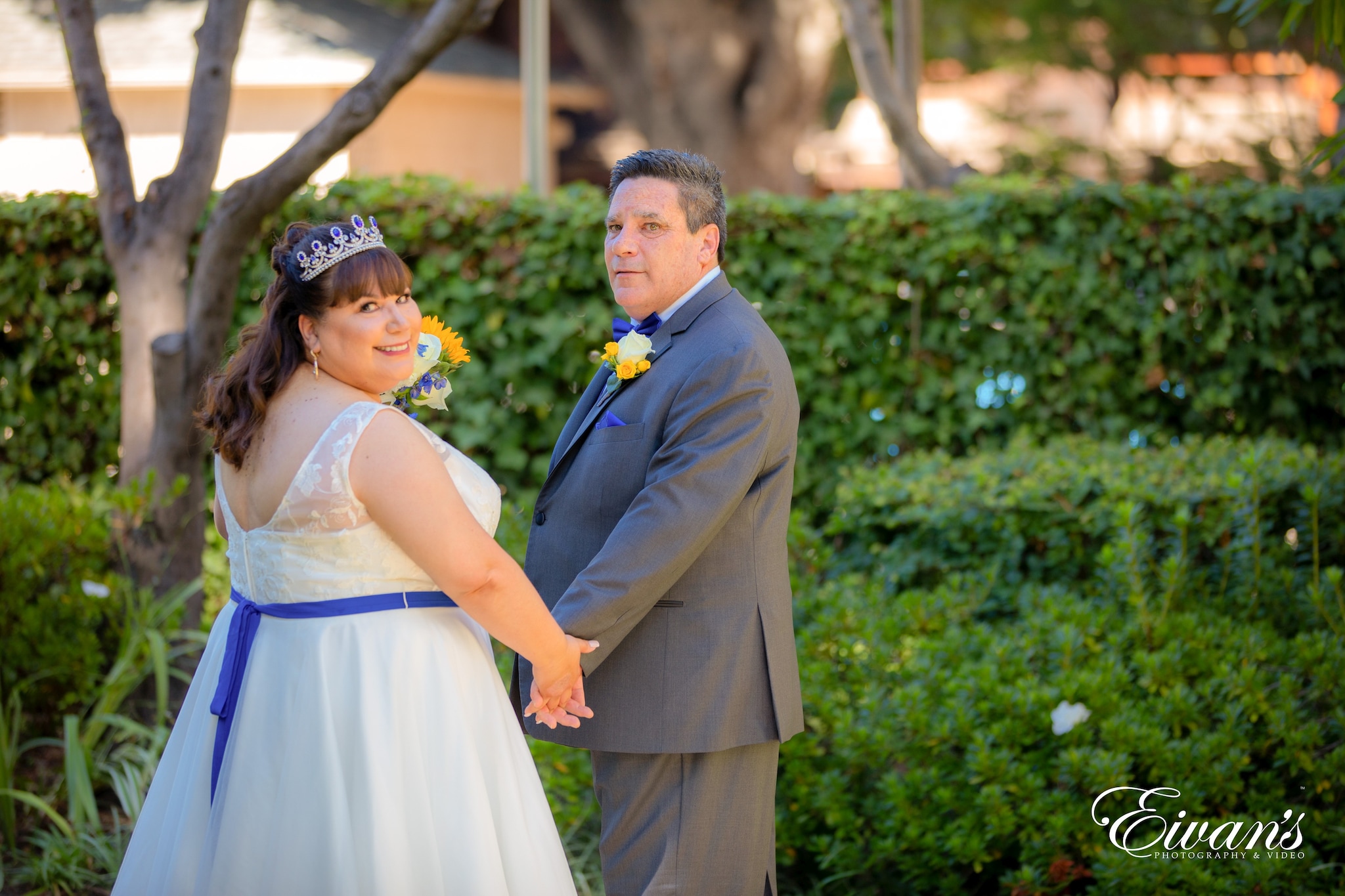 man in black suit and woman in white dress