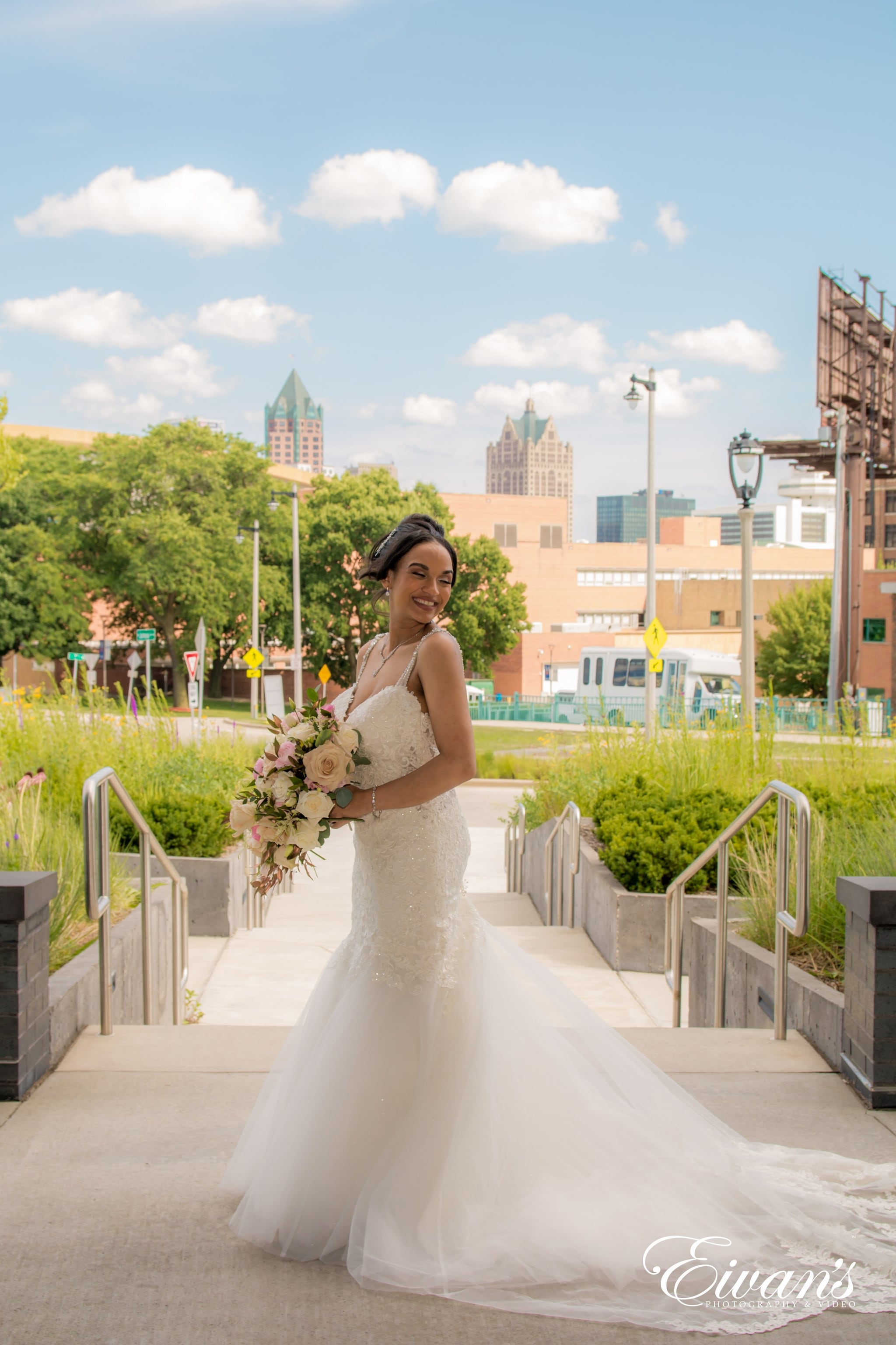 woman in white wedding gown holding bouquet of flowers