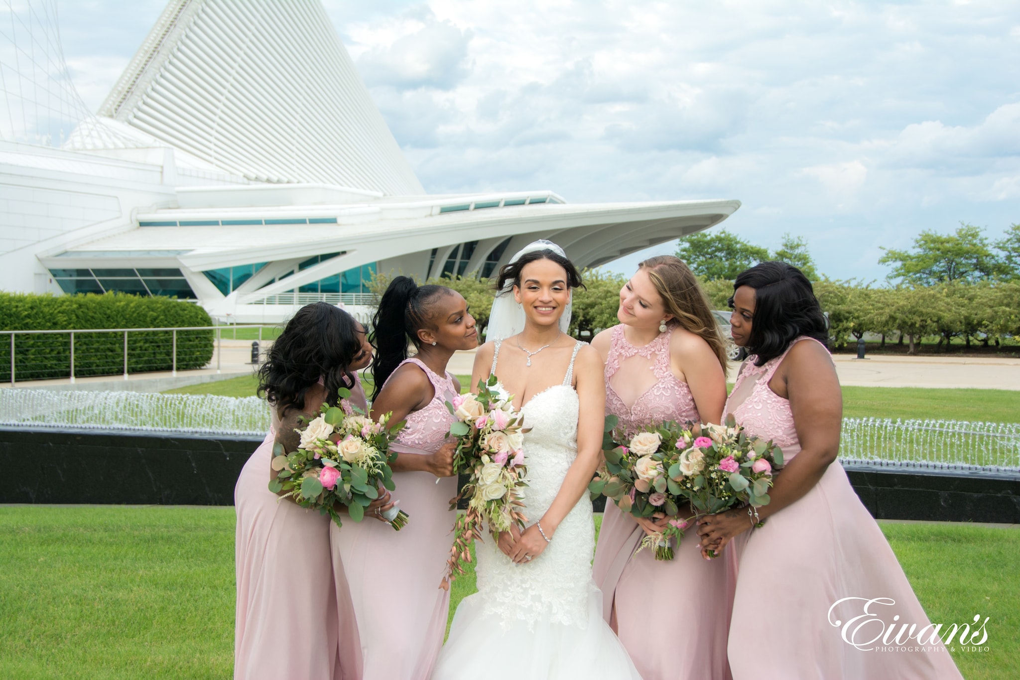 woman in white wedding gown holding bouquet of flowers