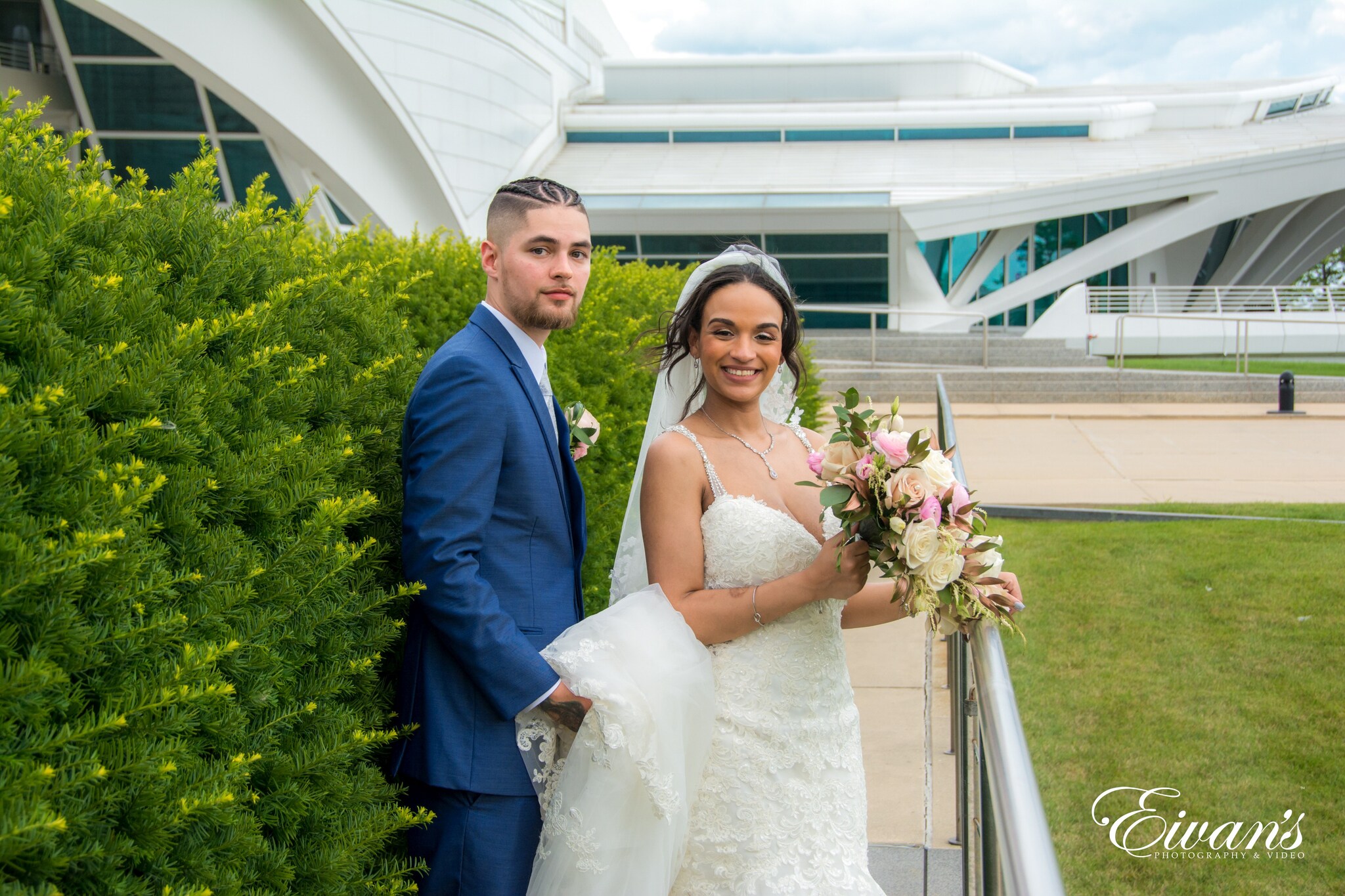 woman in white wedding gown holding bouquet of flowers