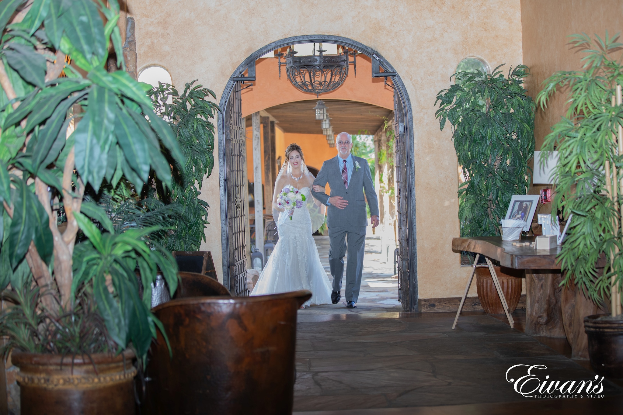 man and woman standing near green plant