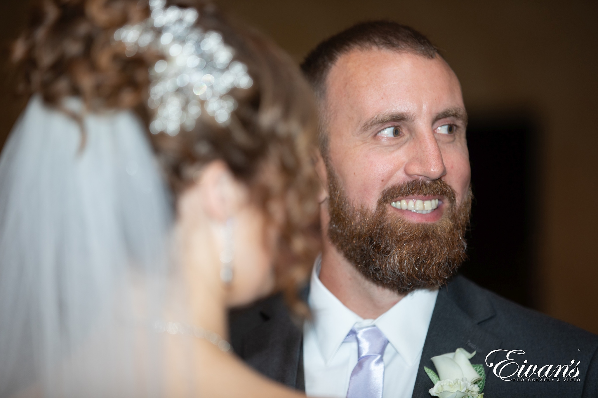 man in black suit jacket smiling