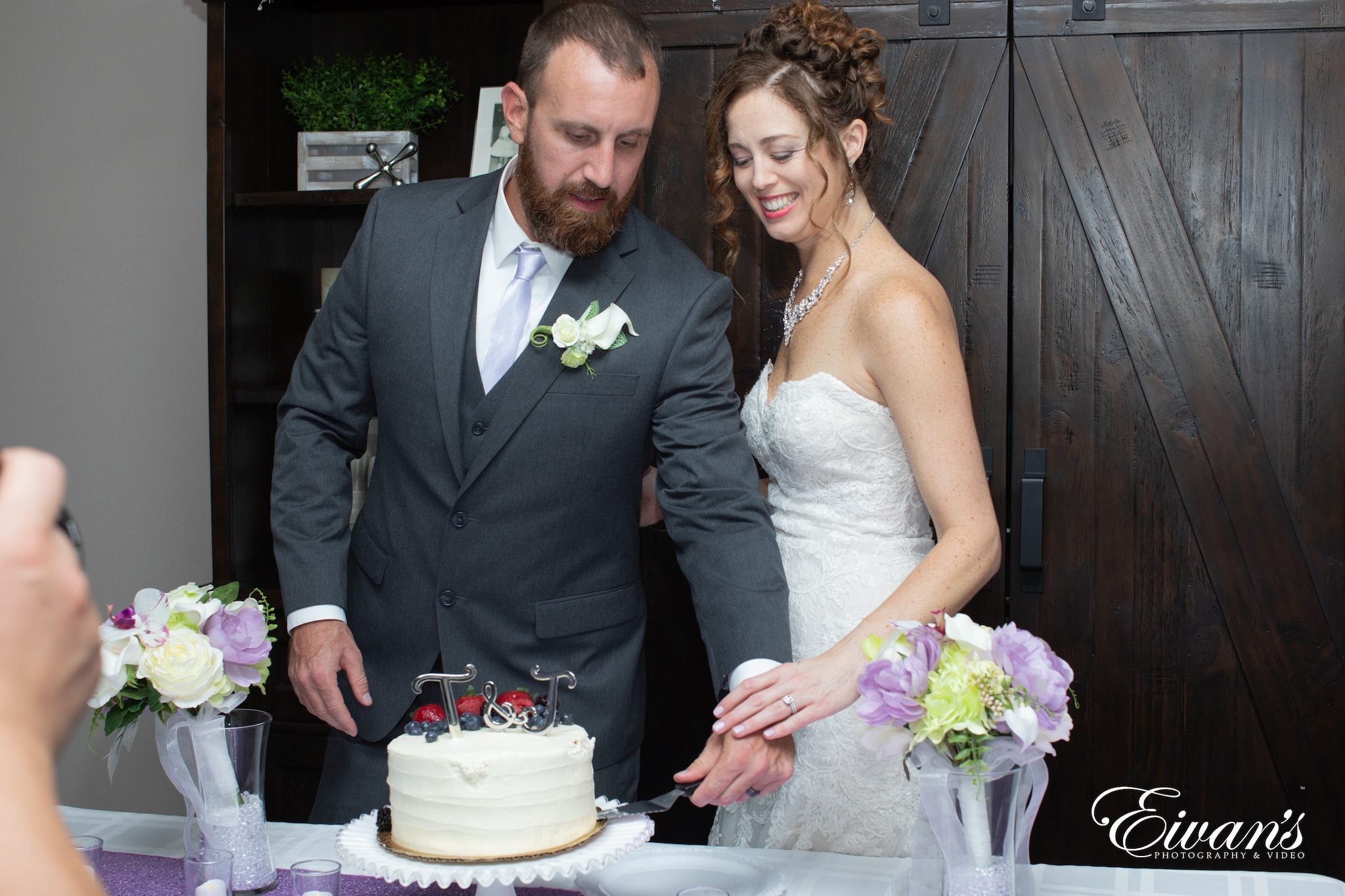 man in black suit and woman in white wedding dress