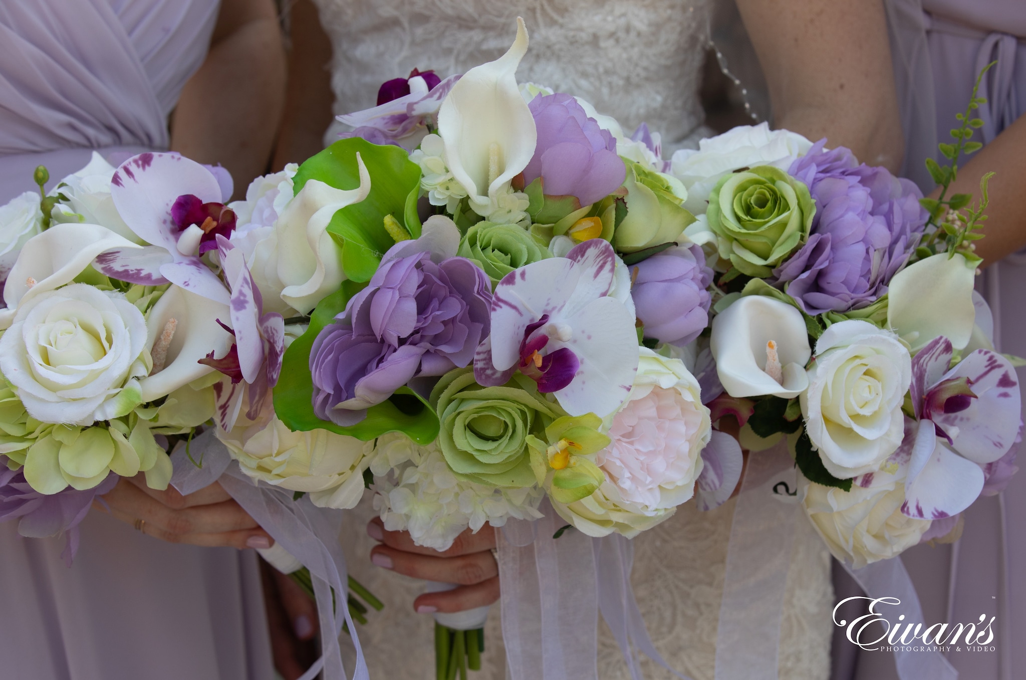 woman in white wedding dress holding bouquet of pink and white roses