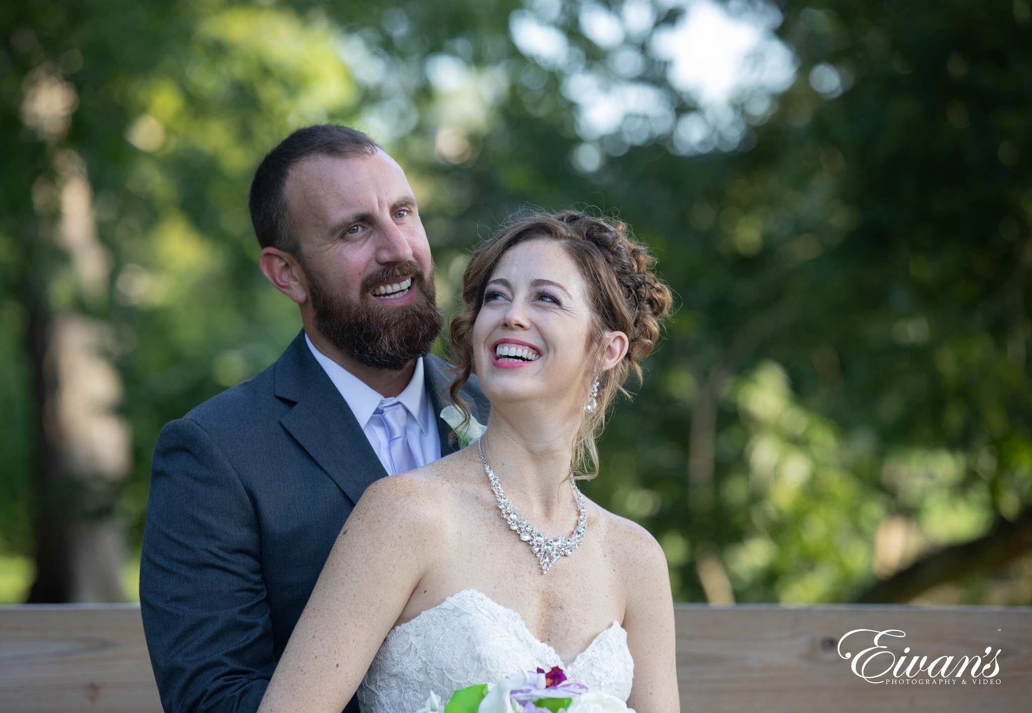 man in black suit jacket kissing woman in white wedding dress