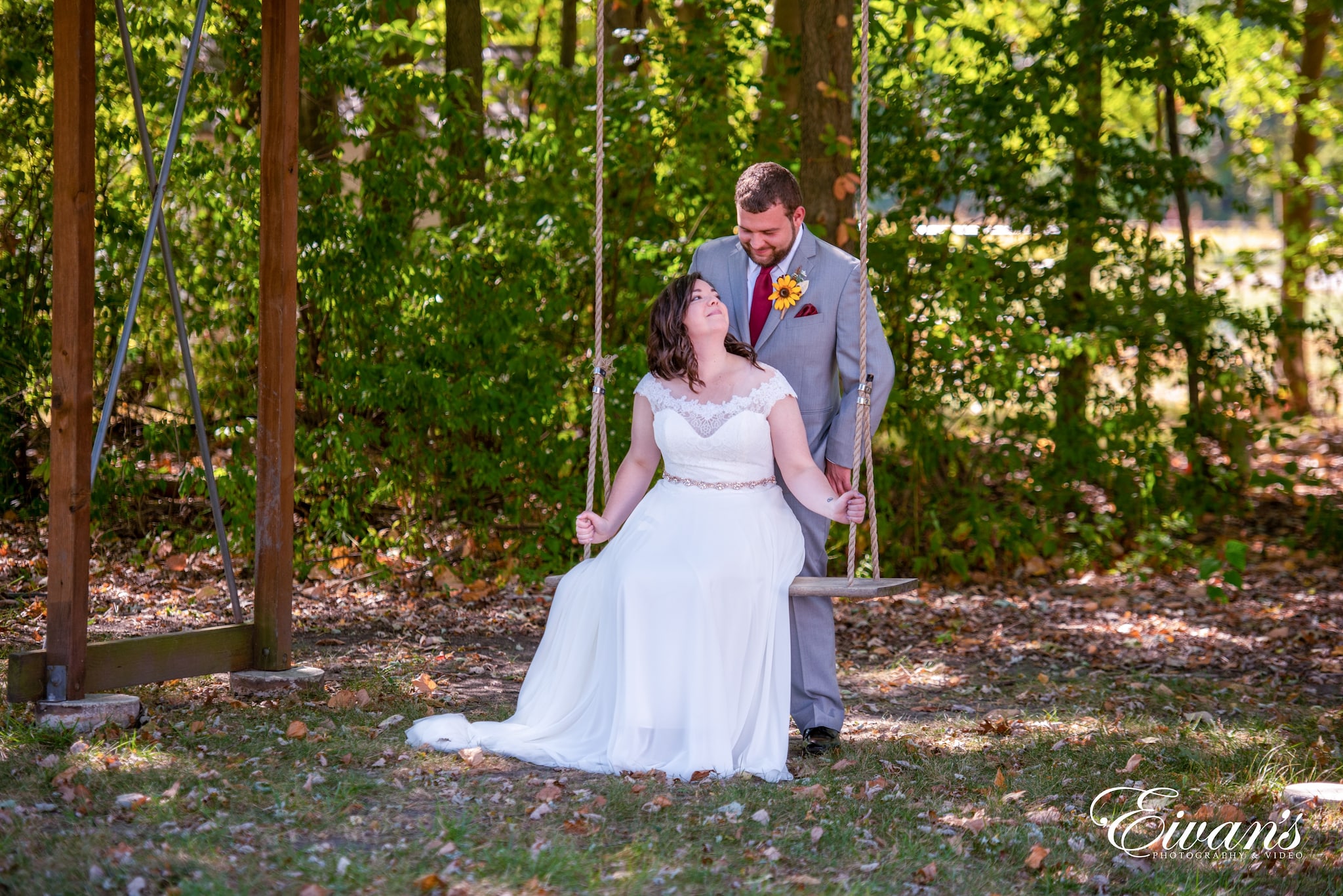 man and woman in wedding dress kissing on green grass field during daytime