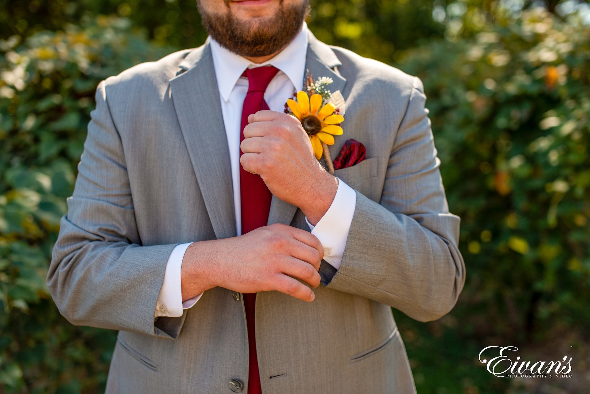 man in gray suit jacket and orange necktie