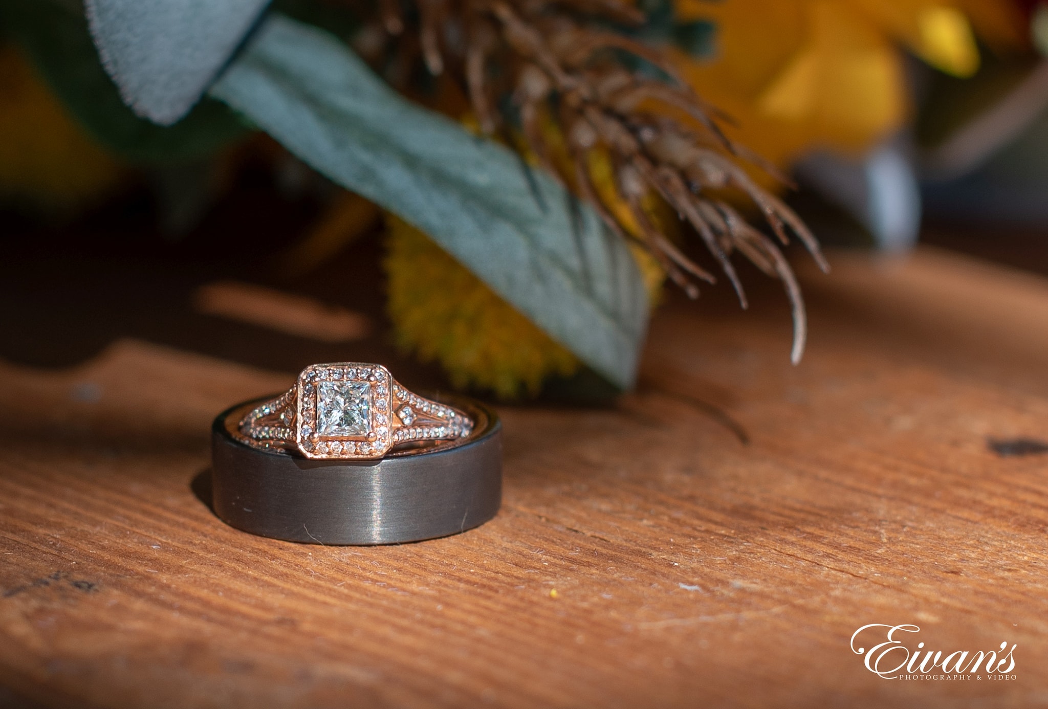 silver and gold ring on brown wooden table