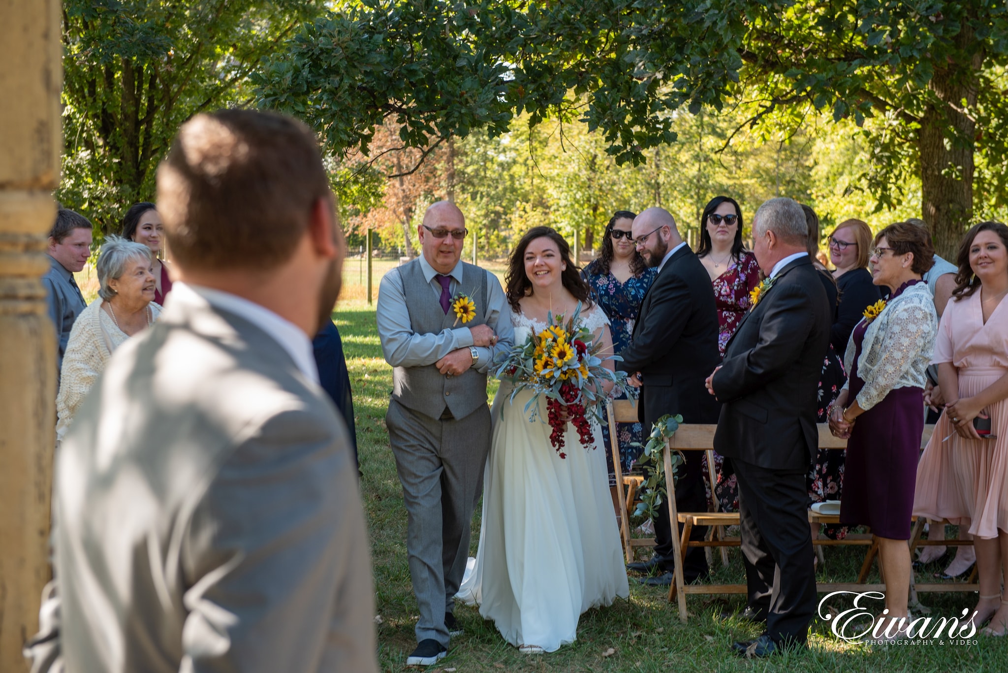 man in white suit standing beside woman in white dress