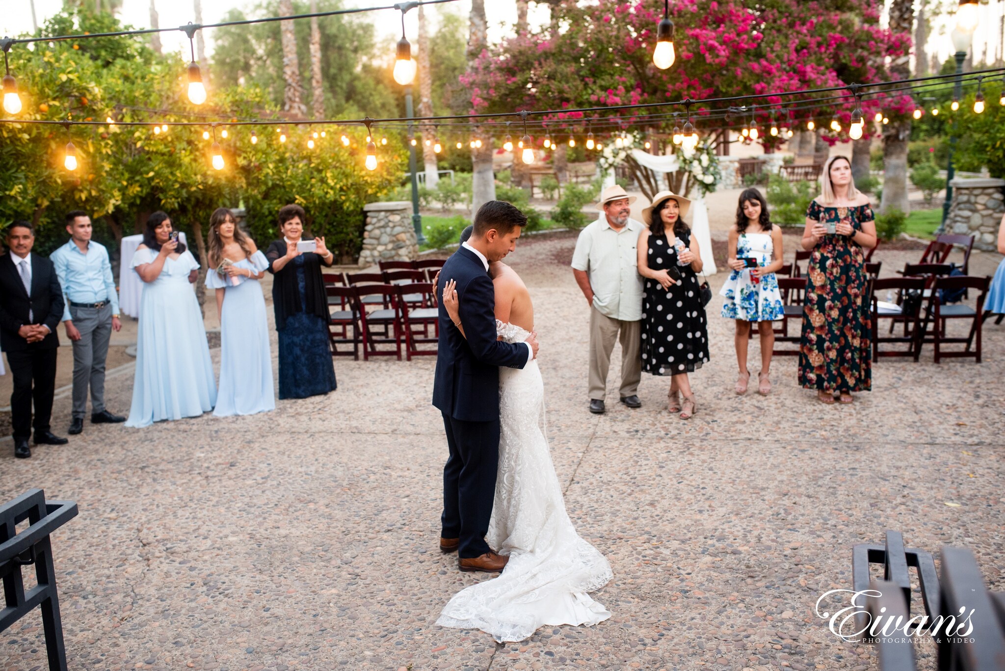 woman in white wedding gown standing beside man in black suit