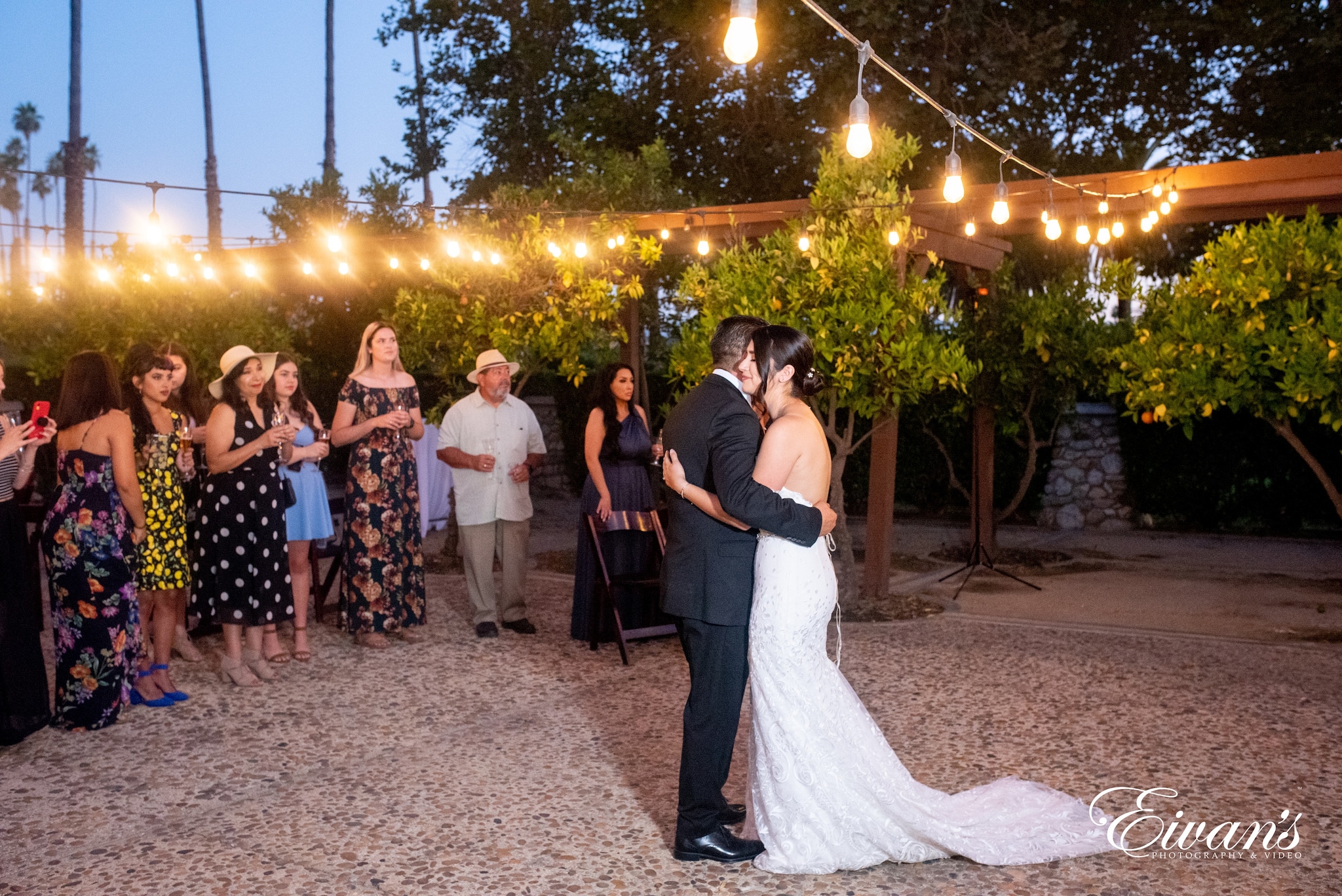 group of people standing on gray sand during nighttime