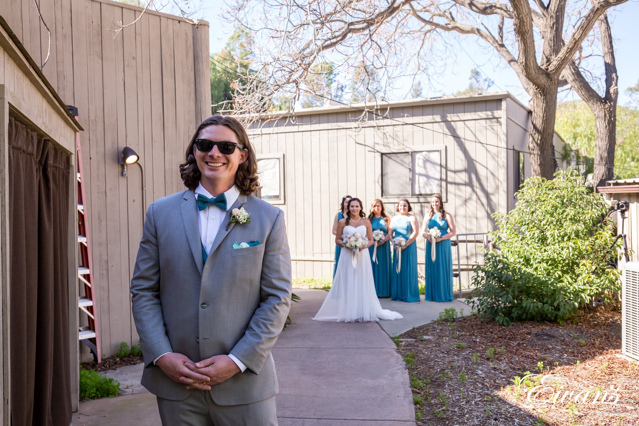 man in gray suit jacket standing beside woman in white wedding dress