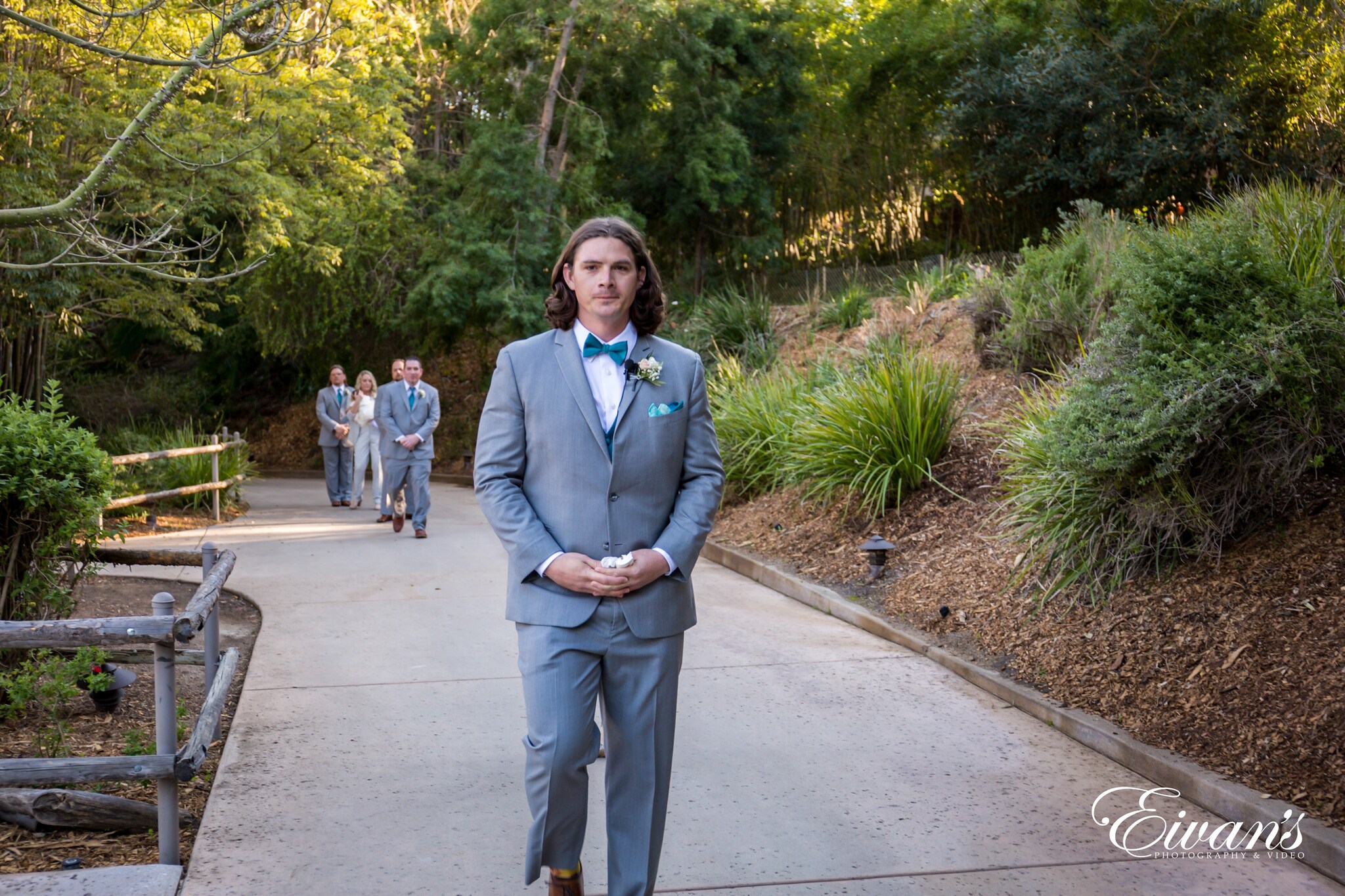 man in gray suit standing on gray concrete floor